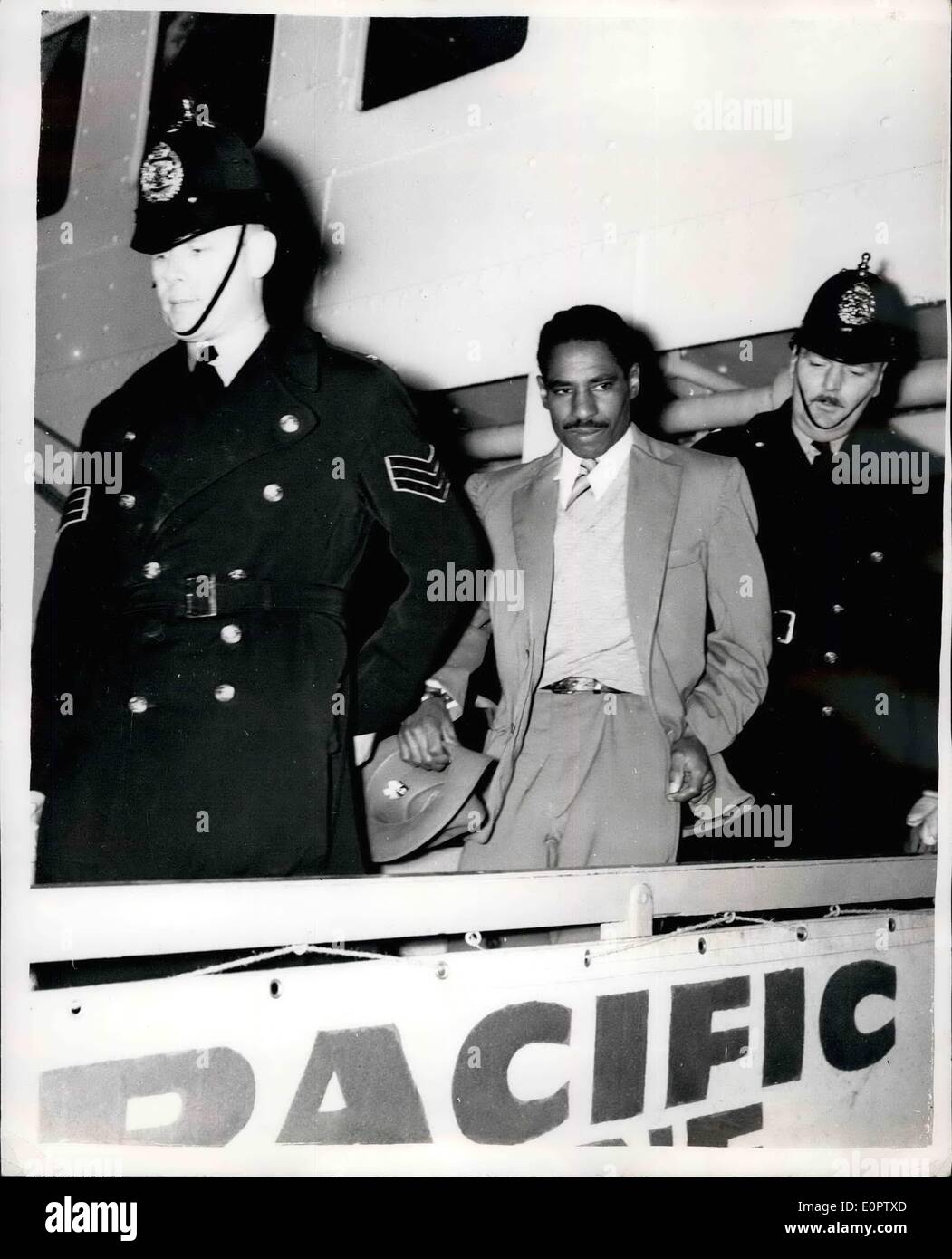 Jan. 01, 1957 - ''The convict no prison can hold'' arrives in Britain: 36-years old George Leroy Matthews, who is known as the convict no prison can hold - arrived at Plymouth yesterday in the liner Reina Del Pacific. Matthews, a ethnic burgler, has been sent to Britain by the Bermuda authorities to complete a ten years sentenced imposed in 1949. He escaped five times from Hamilton, Bermuda, goal and three times from a New York goal. Photo shows George Leroy Matthews, is escorted from the liner by two policemen, after his arrival at Plymouth yesterday. Stock Photo