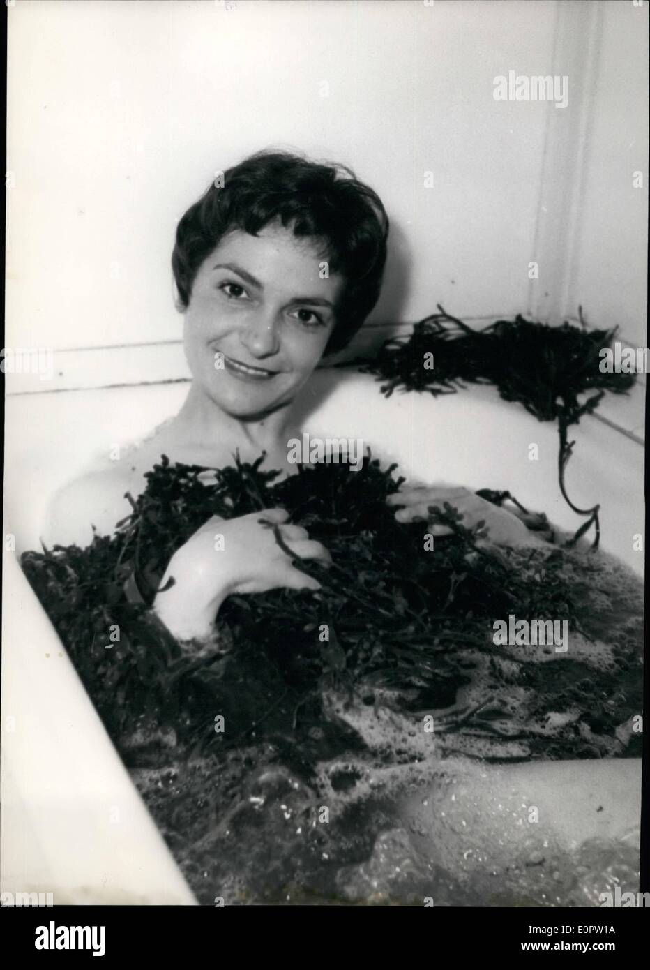 Mar. 03, 1957 - Starlet: Nothing like seaweed bath to keep fit: Nathalie Keryan, the young Paris stage actress, takes a seaweed Stock Photo