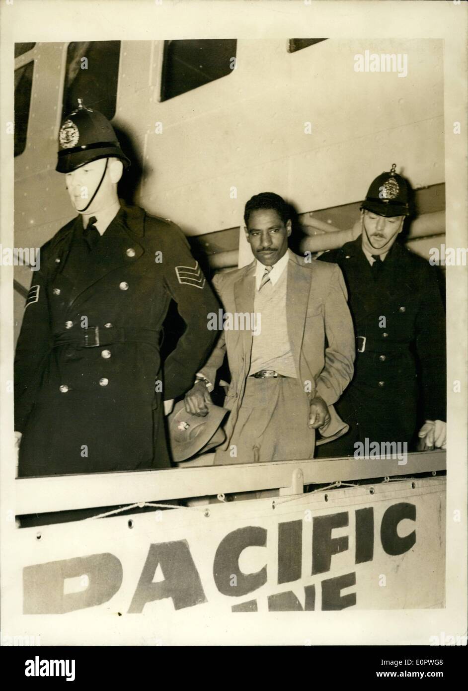 Jan. 01, 1957 - ''The Convict No Prison Can Hold'' Arrives In Britain: 36-years old George Leroy Matthews, who is known as the convict no prison can hold - arrived at Plymouth yesterday in the liner Reina del Pacifico. Matthews, a ethnic burgler, has been sent to Britain by the Bermuda authorities to complete a ten years sentenced imposed in 1949. He escaped five times from Hamilton, Bermuda, goal and three times from a New York goal. Photo shows George Leroy Matthews, is escorted from the liner by two policemen, after his arrival at Plymouth yesterday. Stock Photo