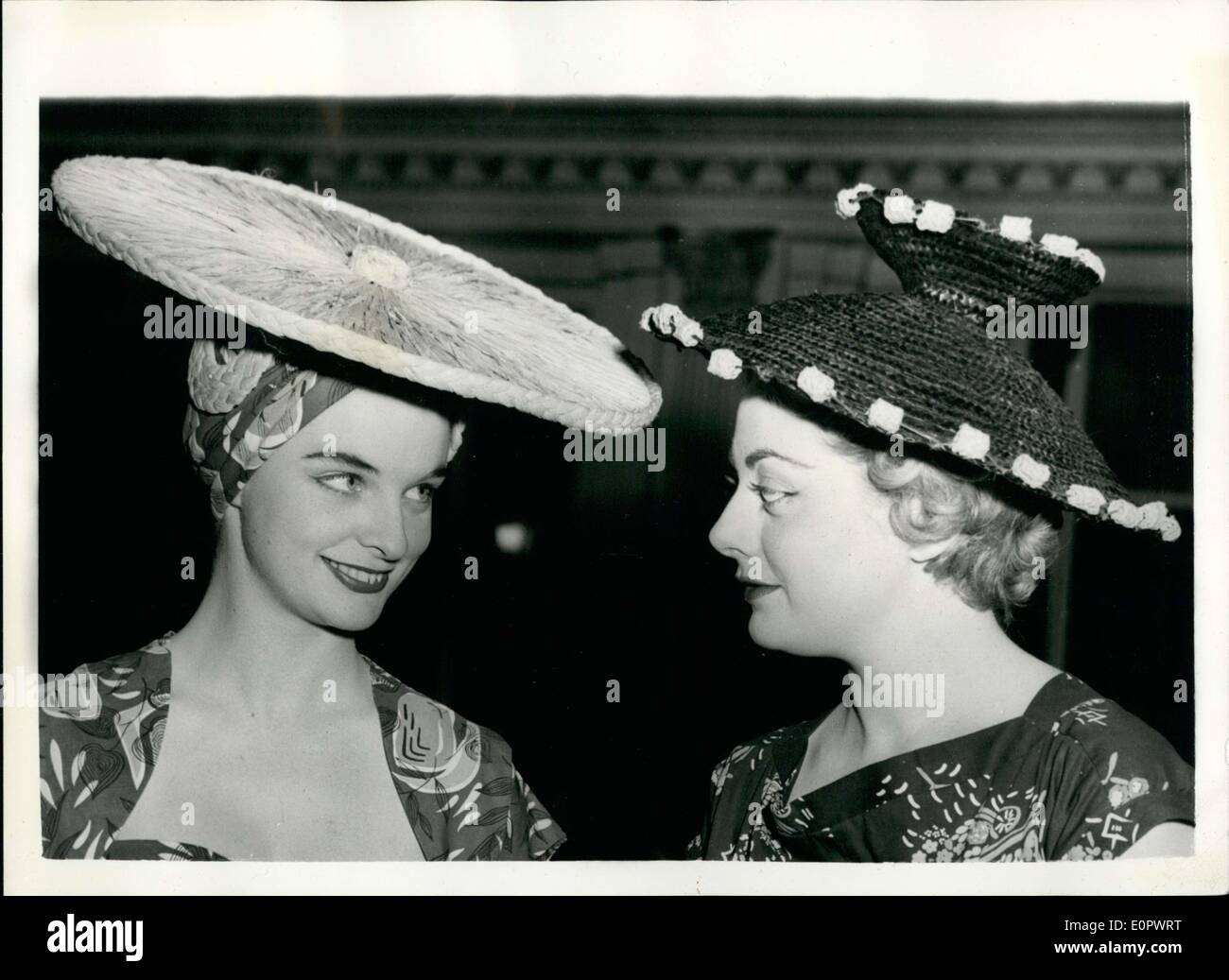Jan. 07, 1957 - Commonwealth Parade of fashion in London: A rehearsal was held at the Cafe Royal, London this afternoon for tomorrow's Commonwealth Parade of Fashion in which styles from many parts of the world made from Lancashire Cotton will be shown. Photo shows two hats left: Faye Bresner wears a large sunhat in natural raffia and Dorothea Stafford wears creation in black straw with blue bobbles. Stock Photo
