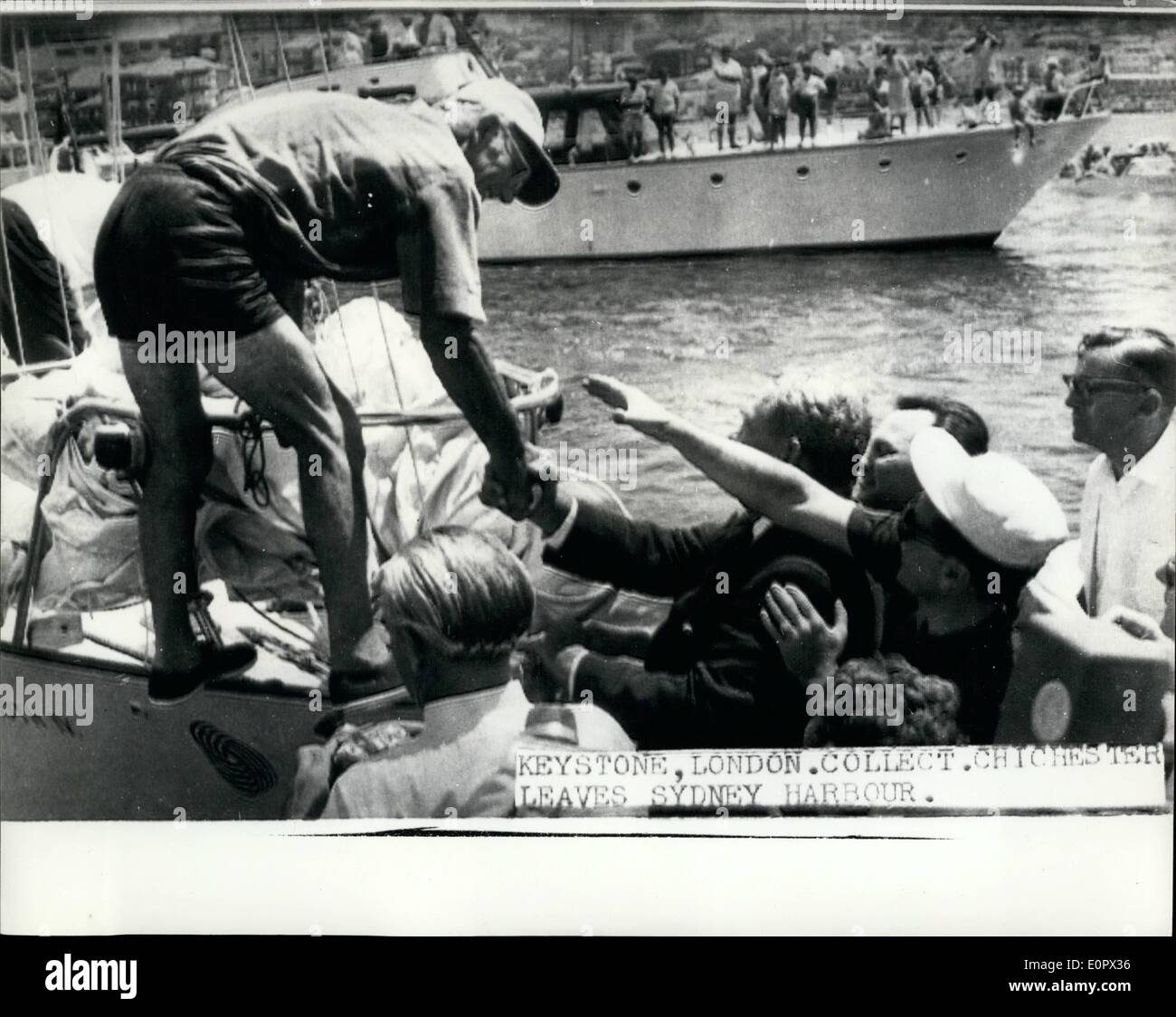 Jan. 29, 1957 - 29-1-57 Lone yachtsman Francis Chichester leaves Sydney on his perilous voyage back to England. Lone yachtsman Francis Chichester sailed out from Sydney Harbour today in his famous yacht Gipsy Moth IV for his voyage back to Plymouth round Cape Horn. The Queen sent a good-luck message to Chichester yesterday, whom she had made a Knight the previous day. Photo Shows: Francis Chichester shakes hands with well-wishers as he boards his yacht Gipsy Moth IV in Sydney Harbour before leaving on his voyage back to Plymouth today. Stock Photo