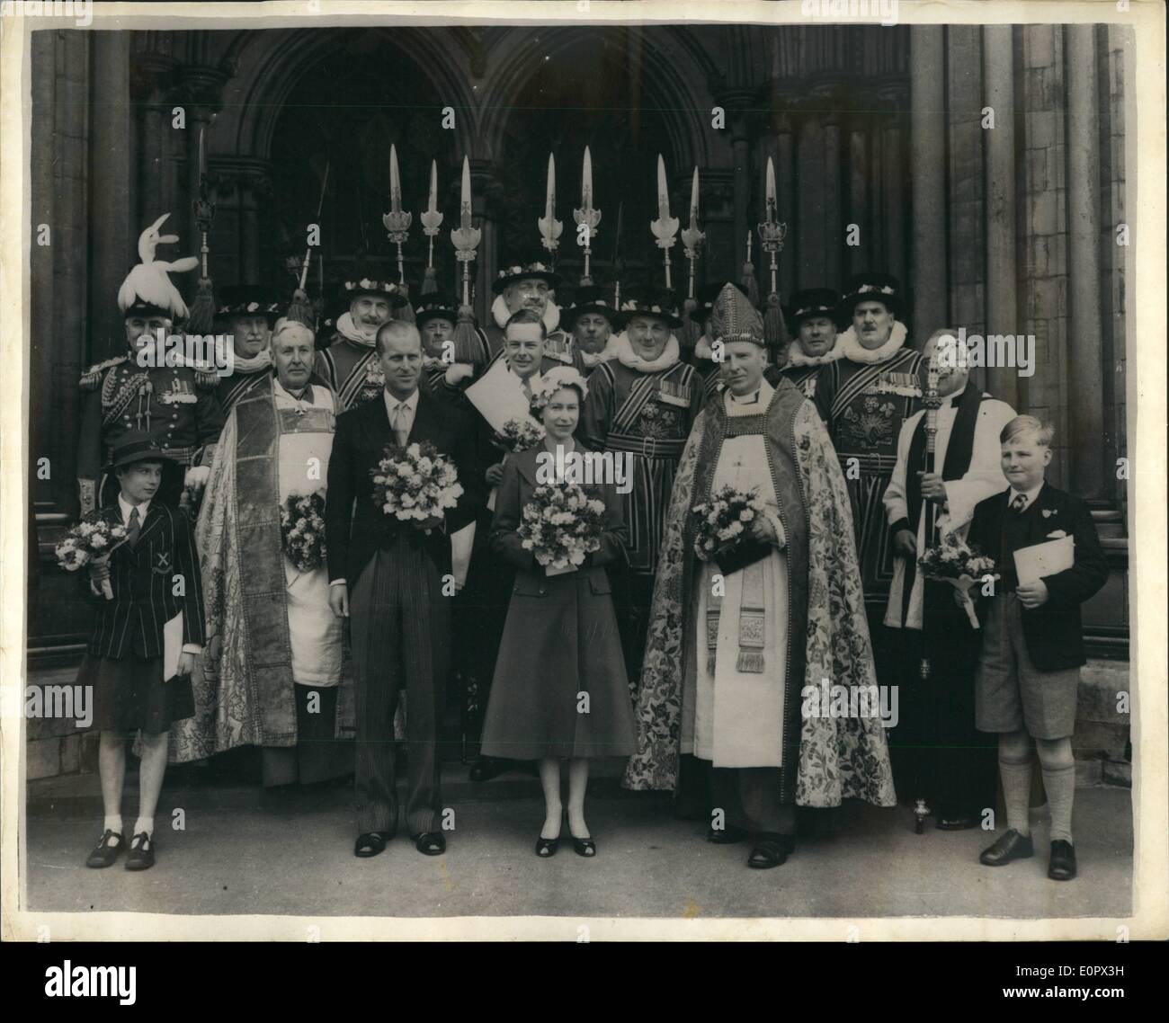 Apr. 04, 1957 - The Queen and Prince Philip Distribute Maundy Money at St. Albans-Abbey for the First Time: The aged and needy folk of St. Albana received the Royal Maundy Money from the Queen today, the first time since Charles ''11'' is reign that this ancient ceremony has been held outside London. Usually it is held at Westminster Abbey. Photo shows Queen Elizabeth and Prince Philip with officials and Yeomen, after the distribution by Her Majesty of the traditional Royal Maundy Money at St. Albans Abbey today Stock Photo
