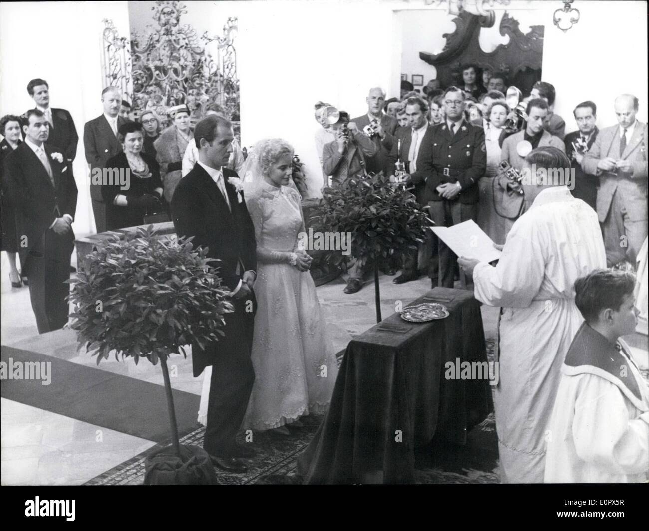 Apr. 04, 1957 - Movie-actress weds in the ''Wies'' Church: The Wedding of the Swiss-movie-actress Maria Schell and movie director Horst Hoechler took place in one of the most beautiful Churches of Upper- Bavaria, the charming rococo- building by Dominikus Zimmermann (1964-1754), near Stingaden. The wedding-ceremonial was performed by parson Johann Oberbauer. Picture Shows: Maria Schell and Horst Haechler infront of the altar. To the right- Parson Johann Oberbauer. In the background Bernhard Wicki, co-actor of Maria Schell in the movie ''The last bridge'', next to him- Maria Schell's mother Stock Photo
