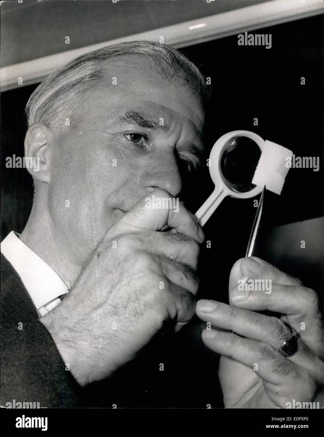 Apr. 04, 1957 - National Stamp exhibition. The 15th. Annual National Stamp Exhibition, known as ''Stampex'', was opened today by the Postmaster General, Mr. Edward Short, M.P., at the Central Hall, Westminster. Photo shows Mr. Edward Short, M.P., the Postmaster General, seen examining a rare Swiss stamp, when he toured the exhibition today. Stock Photo
