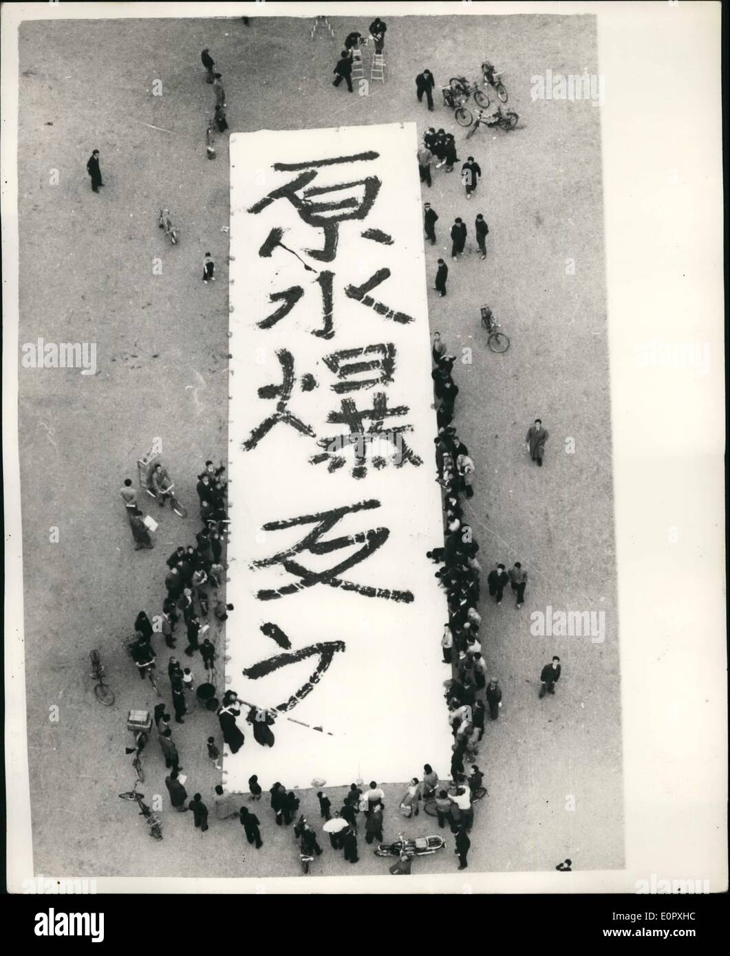 Apr. 04, 1957 - Giant Anti H-Bomb Plea. A giant anti atomic and hydrogen bomb plea, probably the world's largest written by a single man, is shown nearing completion as a Japanese expert calligrapher tackles a 13-kilogram giant writing brush to write five big Chinese letters meaning ''opposition to A-and-H-bombs on a 250 sq. metre Japanese paper. The writing of the plea took place in the compound of an Osaka shrine, on Mar.30. 50-year-old Shoshichi Nakatsu, in his ceremonial kimono, did the job, wishing success to a Japanese Government's anti H-bomb mission that left for London the same day Stock Photo