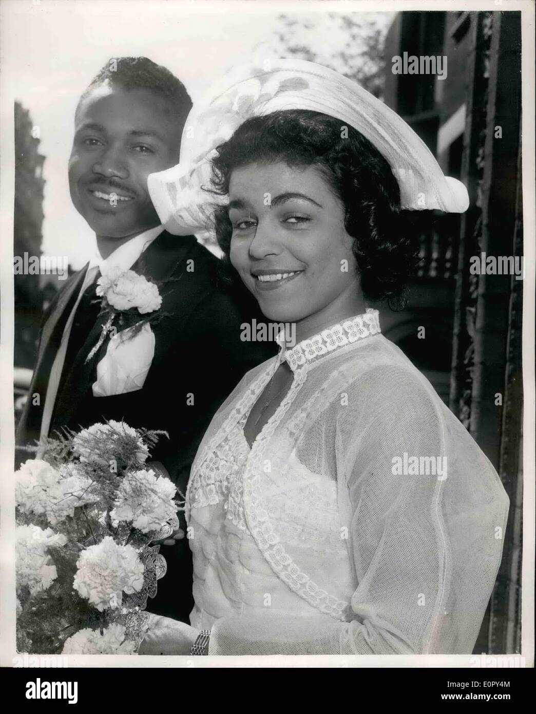 May 05, 1957 - Calypso singer weds U.S. Sergeant: Calypso singer, Mahala Davies, who sings in the B.B.C. program Calypso Calling, was married at Kensington Register Office today, to U.S. Army sergeant, Earl Wilkerson, of Jacksonville, Florida. Mahala, who comes from Tiger Bay, Cardiff, has a Welsch mother and Jamaican father, She leaves for Helsinki tomorrow for a three months singing tour. Photo shows the bride and groom after the ceremony. Stock Photo