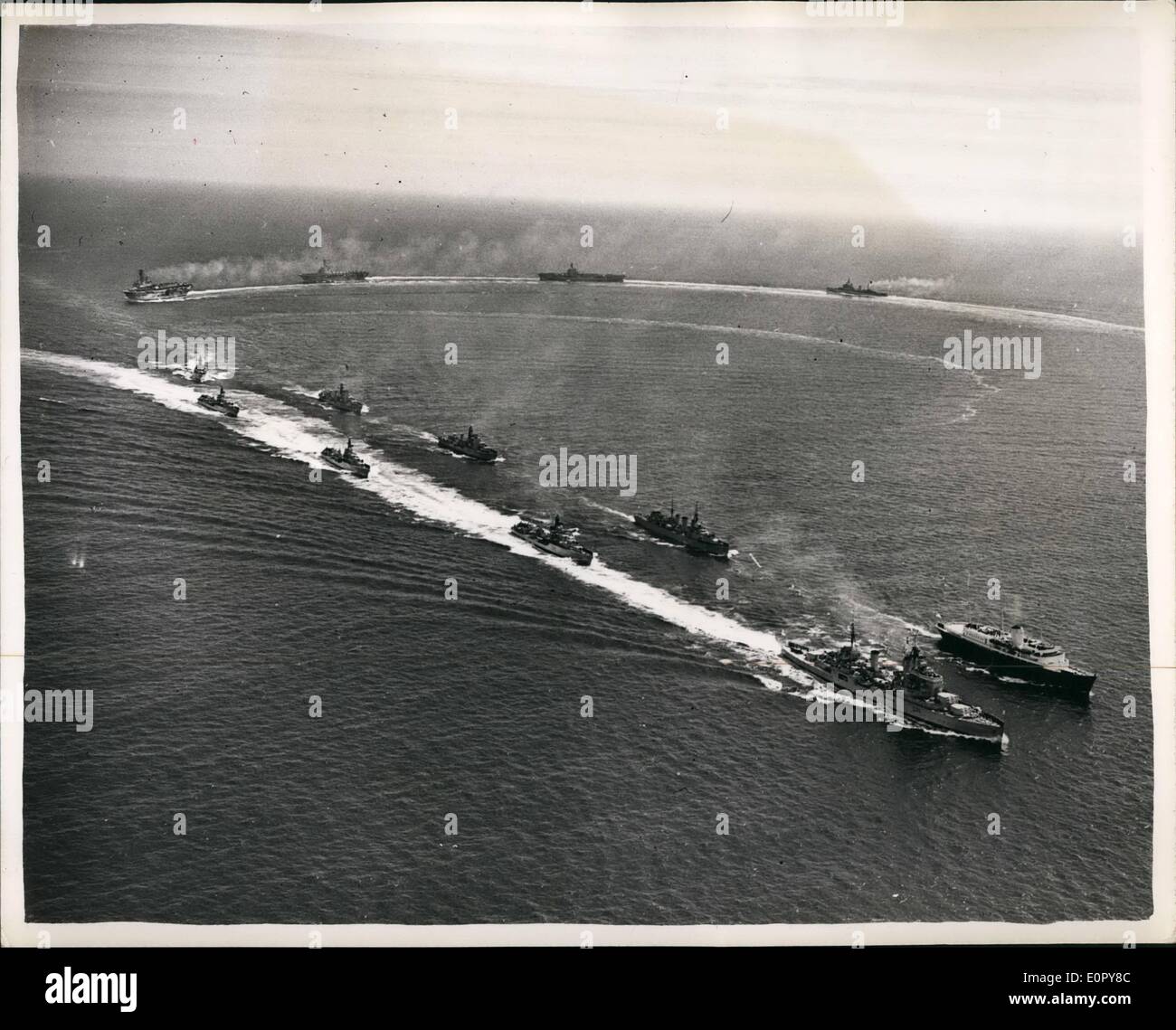 May 05, 1957 - The Home Fleet Greets the Queen.Scene From the Air: The Home Fleet Saluted M.M. the Queen and the Duke of Edinburgh when they arrived in Scottish water yesterday Aboard the Royal Yacht Britannia- from Denmark. the fleet escorted the vessel to anchorage in Cromarty Firth. Photo Shows As seen from the air-front line- the cruiser Superb; destroyers Agincourt- Alamein-Barrosa and corunna. second-Britannia- the mine-laying cruiser Apollc, destroyers Duchess- Diamond. in the rear- the aircraft cariers Ark -Royal- Albion- Ocean and the Cr miser Gambia. Stock Photo