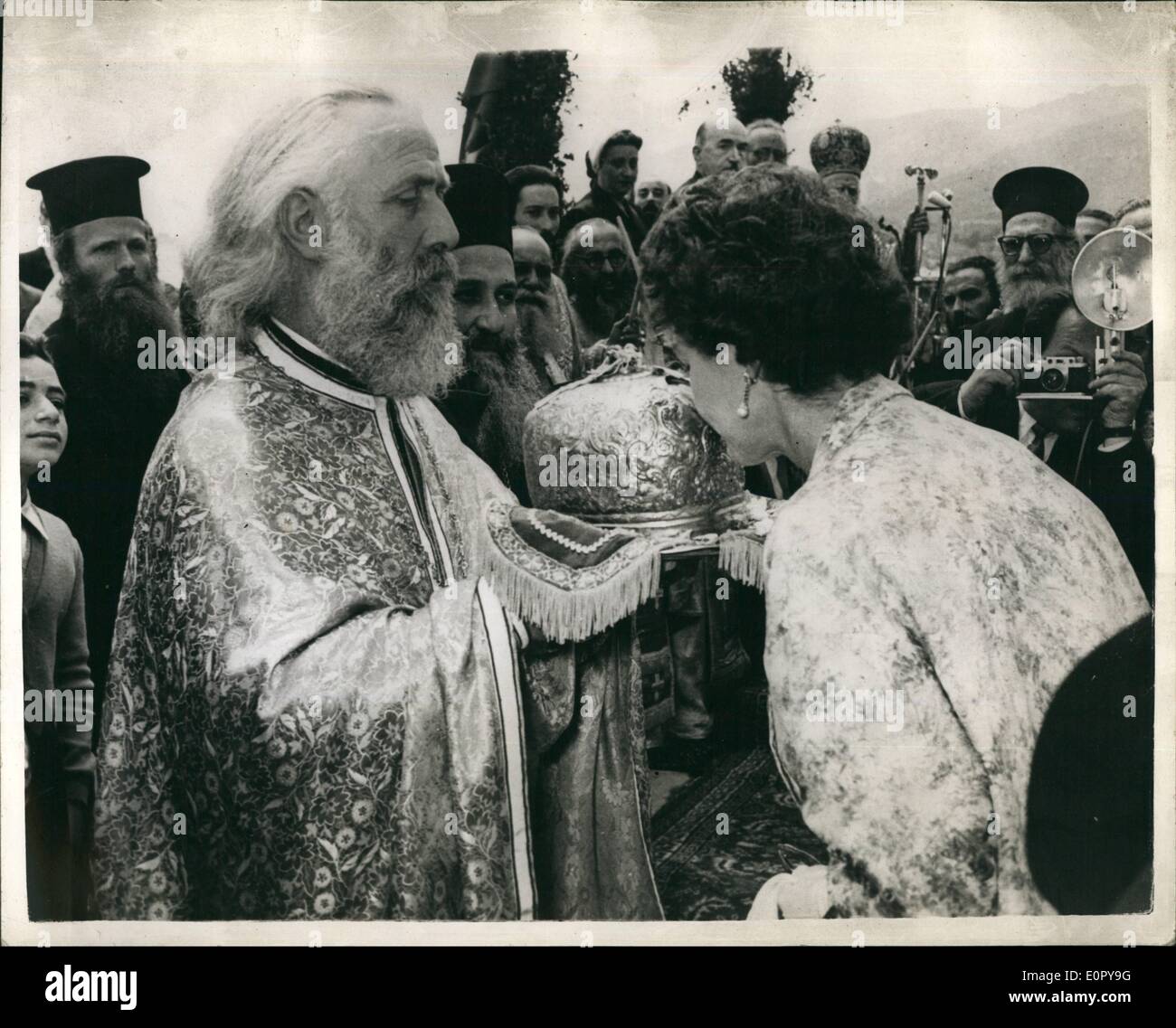 May 05, 1957 - King and Queen of Greece on Spring Tour of the Aegean Islands: King Paul and Queen Frederica of Greece recently carried out their annual Spring Tour of the ancients islands of the Aegean Sea. Photo shows Queen Frederica during to the Island of Mythilene kisses a relic of St. Theodore in the shape of his tiara, presented to her by the Holy Father of St. Theodore Church, during a religious ceremony on the Island. Stock Photo