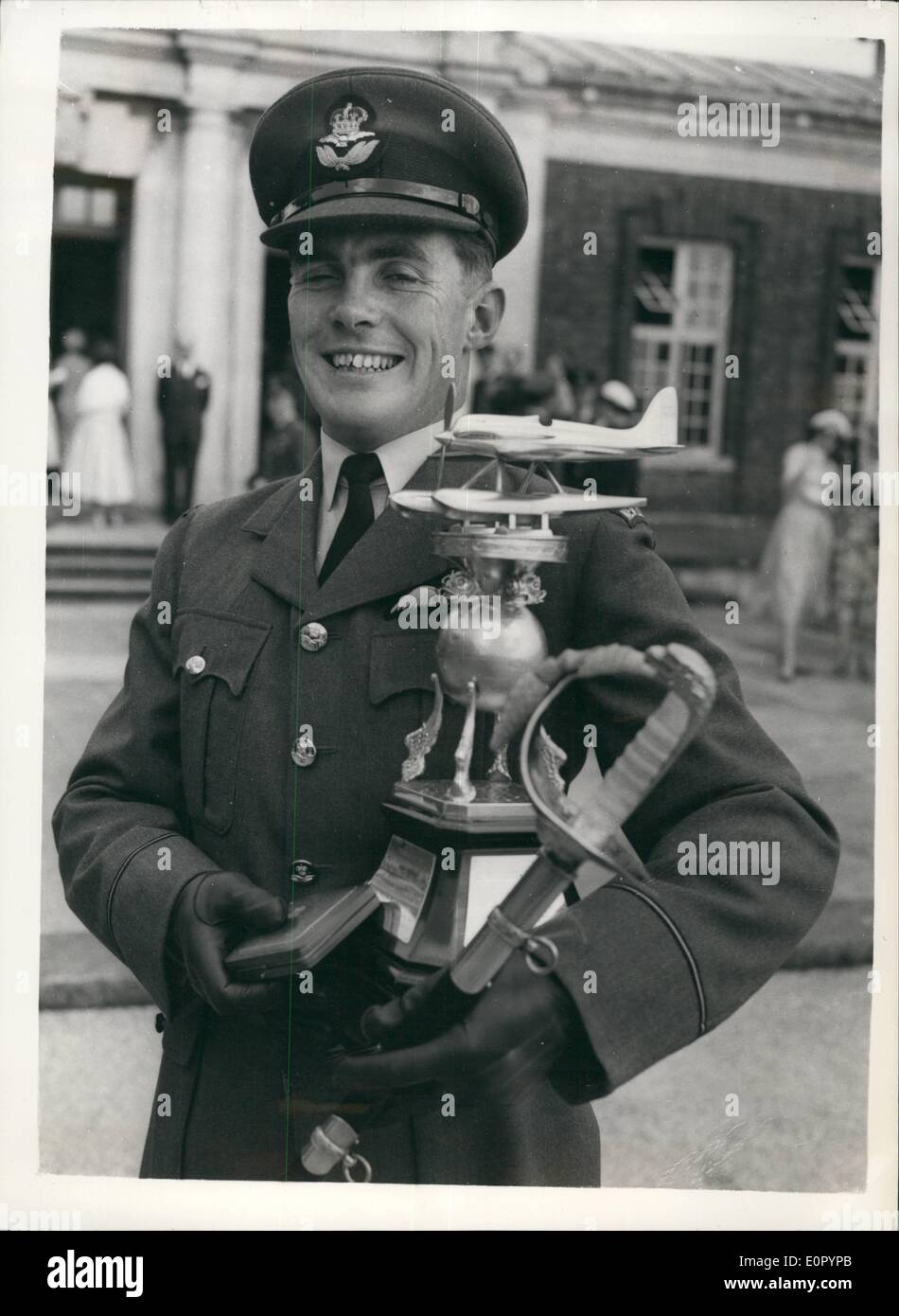 Jul. 07, 1957 - FIRST SEA LORD TAKES SALUTE AT RAF PASSING OUT PARADE. THE BEST -ALL-ROUND-CADET COMES FROM NEW ZEALAND. EARL MOUNTBATTEN of Burma - the Admiral of the Fleet - was the reviewing officer today at the Passing Out Parade of No. 70 Entry - Royal air Force College, Cranwell. Keystone Photo Shows:- Senior under officer T.E. Enright of Dunedin, New Zealand - seen after having received the Sword of Honour, as the best all-round cadet; the QUEEN'S Medal (for the cadet obtaining highest aggregate marks in all subjects ) - and the R.M Stock Photo