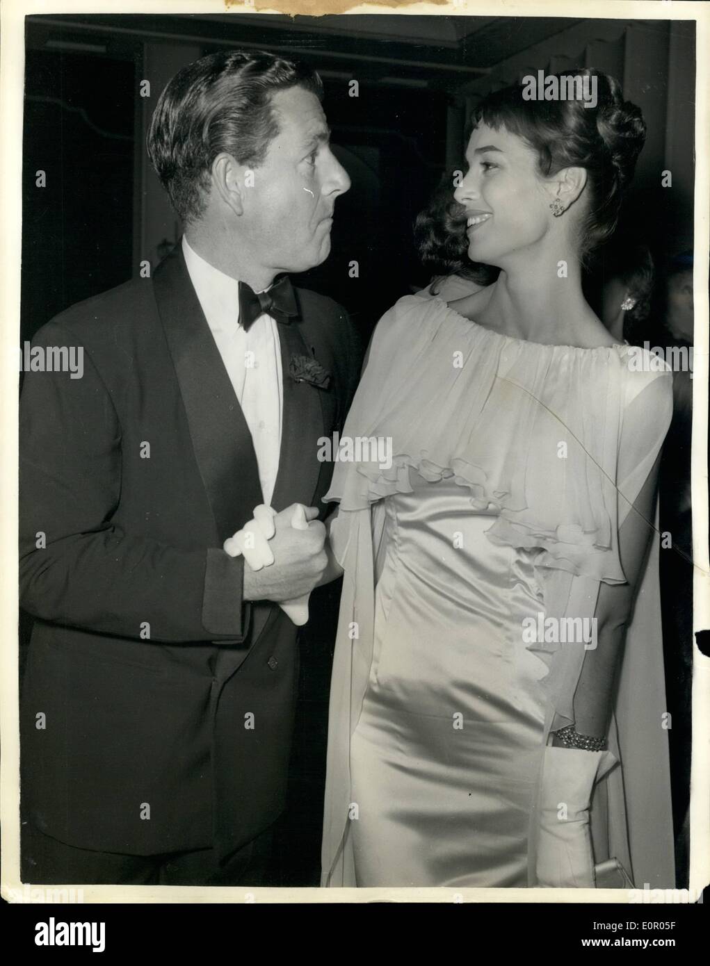 Jul. 07, 1957 - Elsa Martinelli meets Keneth Moore at film Premiere. ''Manuela'' film premiere. Italian screen star Elsa Martinelli seen with British actor Kenneth More when they met at the Odeon Cinema , Marble Arch last night at the premiere of Elsa's new film ''Manuela''. The Duke of Edinburgh attended the premiere which is in aid of charity. Stock Photo