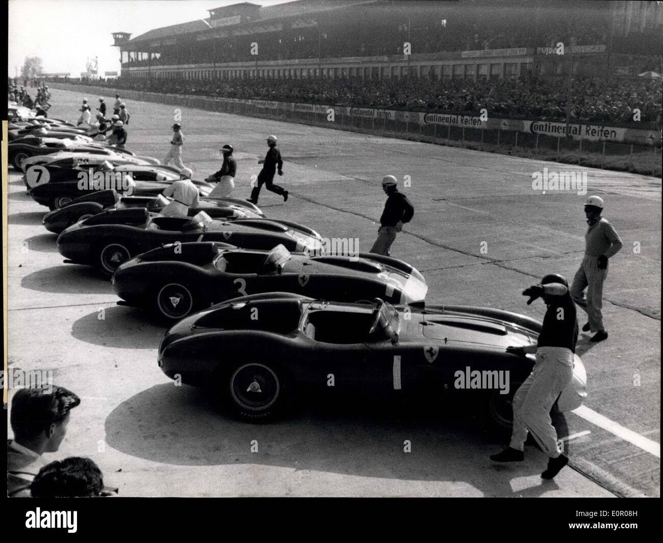 May 26, 1957 - On start for 1000km race at Nurburg-Ring/Germany the cars of the competitors are lined up. In foreground: World-Champion Fangio. Stock Photo