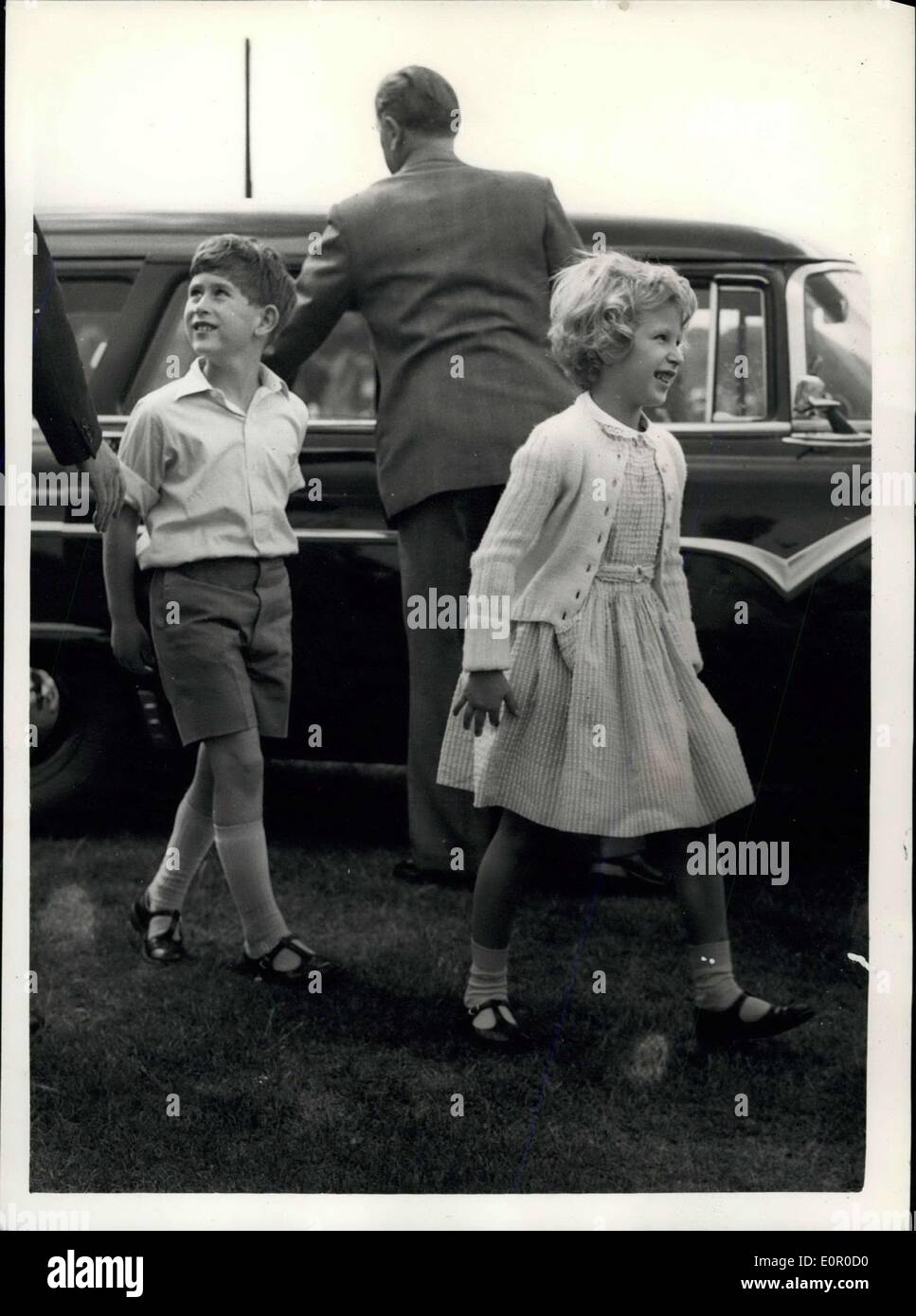 jul-13-1957-prince-charles-and-princess-anne-watch-father-playing-E0R0D0.jpg