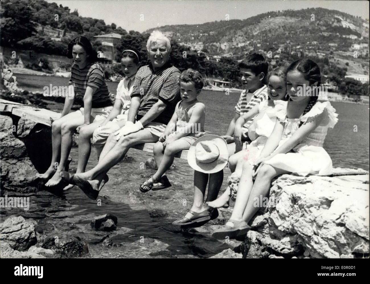 Jul. 14, 1957 - Charlie Chaplin and family on French Riviera : Chaplin and Family are spending their summer Holiday at saint jean cap Ferrat. Photo shows On a little Bridge leading from their Villa to the beach. From L to R : Geraldine, Oona, charlie, Eugene, Josephine, Michael and Victoria. Stock Photo