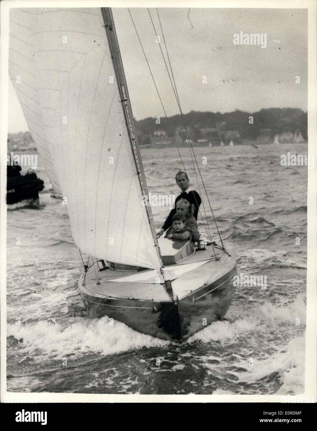 Aug. 06, 1957 - Prince Charles Goes Yacht Racing With His Father At Cowes.: Prince Charles accompanied his father. The Duke of Edinburgh, in the ''Bluebottle'', which is owned by the Duke and the Queen - when competing in a Dragon cless race, in the Cowes Regatta today. Photo shows Prince Charles seen with his father The Duke Of Edinburgh, and Mr. Uffa Fox, aboard the ''Bluebottle'' at Cowes today. Stock Photo