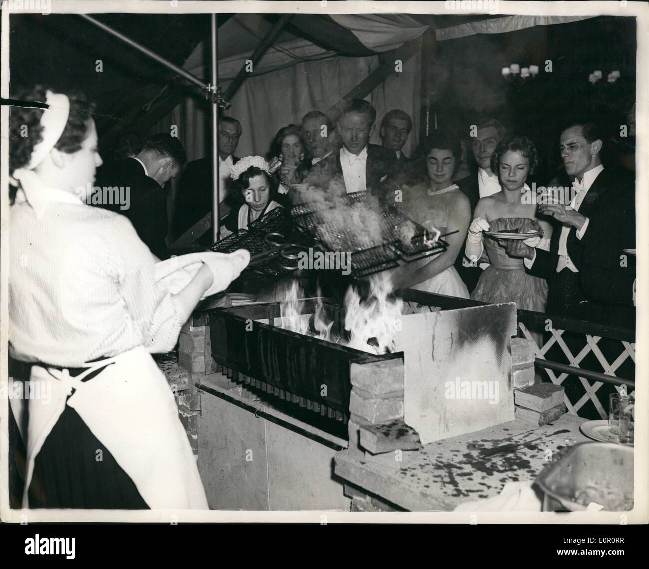 Jun. 06, 1957 - Dance and Barbeque. At London coming-out Party: Guests collect their eats. at the Barbeque which accompanied the coming-out party in honour of MISS CAROLINE FYNNE. at Sussex Place, London, last evening. Stock Photo