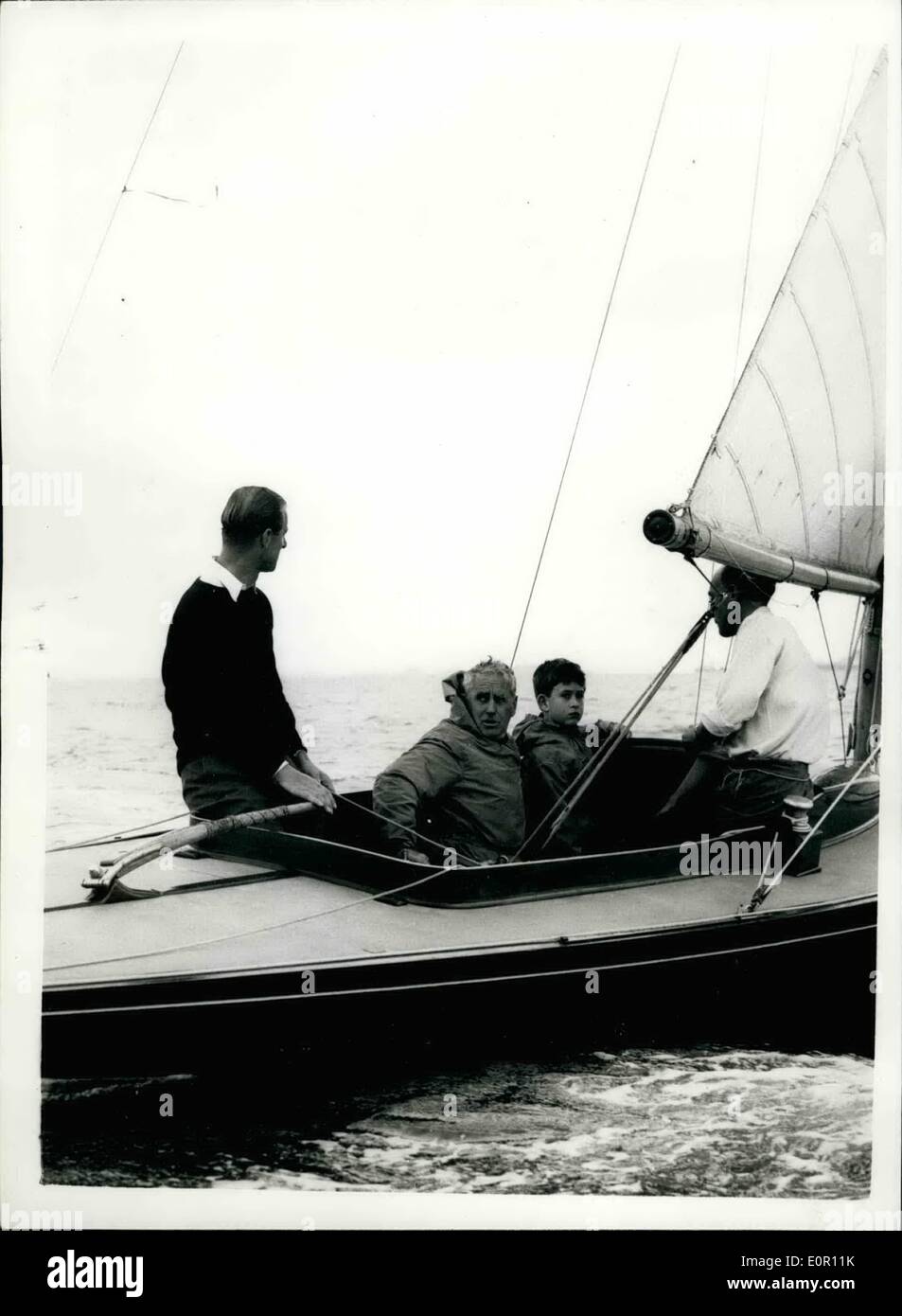 Aug. 08, 1957 - Prince Charles goes yacht - with his father Duke at the tiller abroad ''Bluebottle''. Prince Charles accompanied his father the Duke of Edinburgh in the ''Bluebottle'' - when competing in a dragon class race - during the Goves Rs today. Photo sows the Duke ay the tiller with Prince Chrales and  Fox d- and on right Lieut Commander A.T. Easton. in the 'Bluebottle' at cover today. Stock Photo