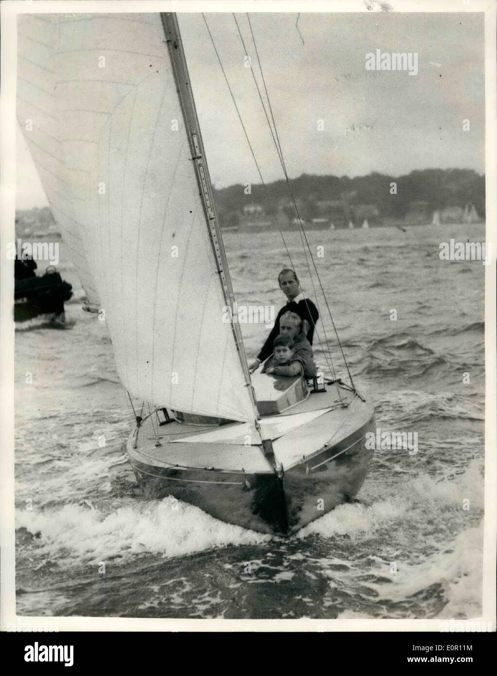 Aug. 08, 1957 - Prince Charles goes yacht racing with his father at Cowes. Prince Charles accompanied his father, The Duke of Edinburgh, in the ''Bluebottle'', which is owned by the Duke and the Queen- -when competing in a dragon class race, in the Cowes Regatta today. Photo shows prince Charles seen with his father the Duke of Edinburgh, and Mr. Uffa Fox, abroad the ''Bluebottle'' at Cowes today. Stock Photo