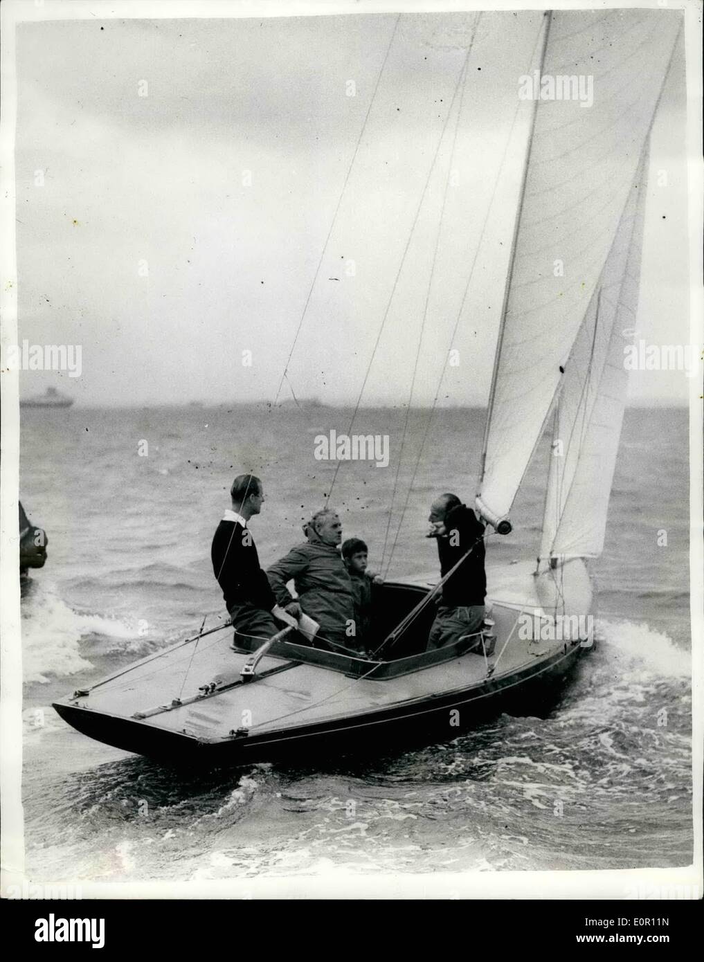 Aug. 08, 1957 - Prince Charles goes yacht racing with his father at Cowes. Prince Charles accompanied his father, The Duke of Edinburgh, in the ''Bluebottle'', which is owned by the Duke and the Queen- -when competing in a dragon class race, in the Cowes Regatta today. Photo shows Prince Charles seen with his father the Duke of Edinburgh, and Mr. Uffa Fox, abroad the ''Bluebottle'' at Cowes today. Stock Photo