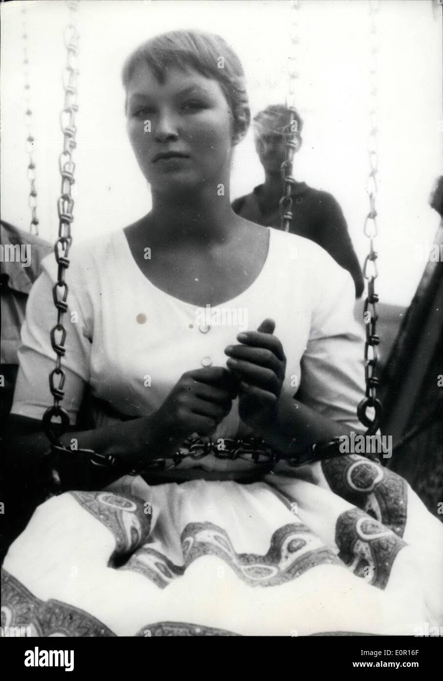Sep. 09, 1957 - Marine Lady chained up? : The reality is not so Grim. The young Franco-Russian Actress who is co-starring with her husband Robert Hossein in the first Franco-czechoslovakian production is seen taking a joy ride on a merry-go-round in a scene made in Eastern Czechoslovakia. Stock Photo