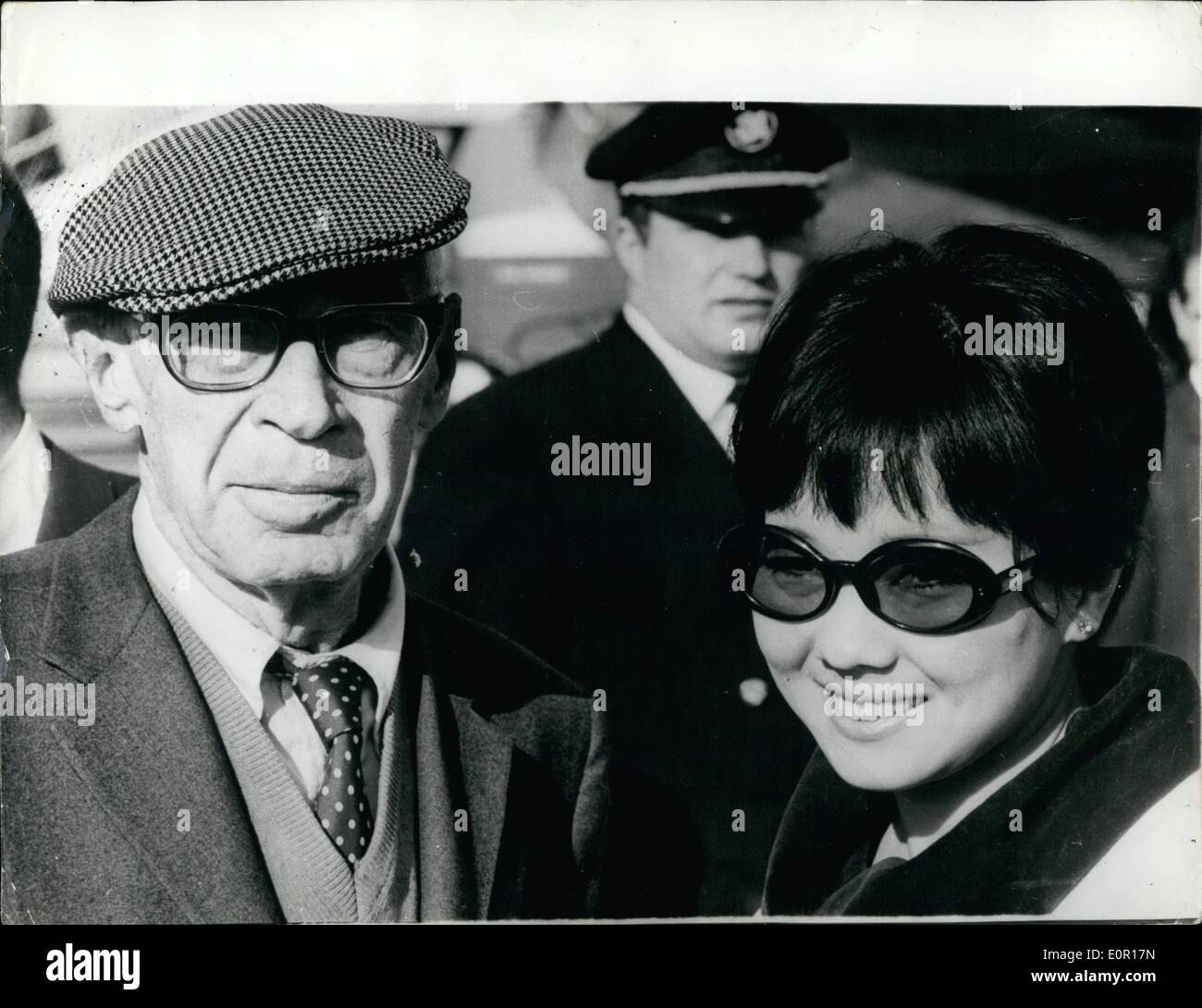Sep. 09, 1957 - Henry Miller and His Bride Arrive in Paris. Henry Miller the 79 year old author from America arrived in Paris this afternoon with his 29 year old Japanese Bride Hoki Tokuda who is a singer. This is Henry Miller's fifth bride. Photo Shows: Henry Miller and his Japanese bride who he married last week in Los Angeles seen arriving in Paris for their honeymoon. Stock Photo