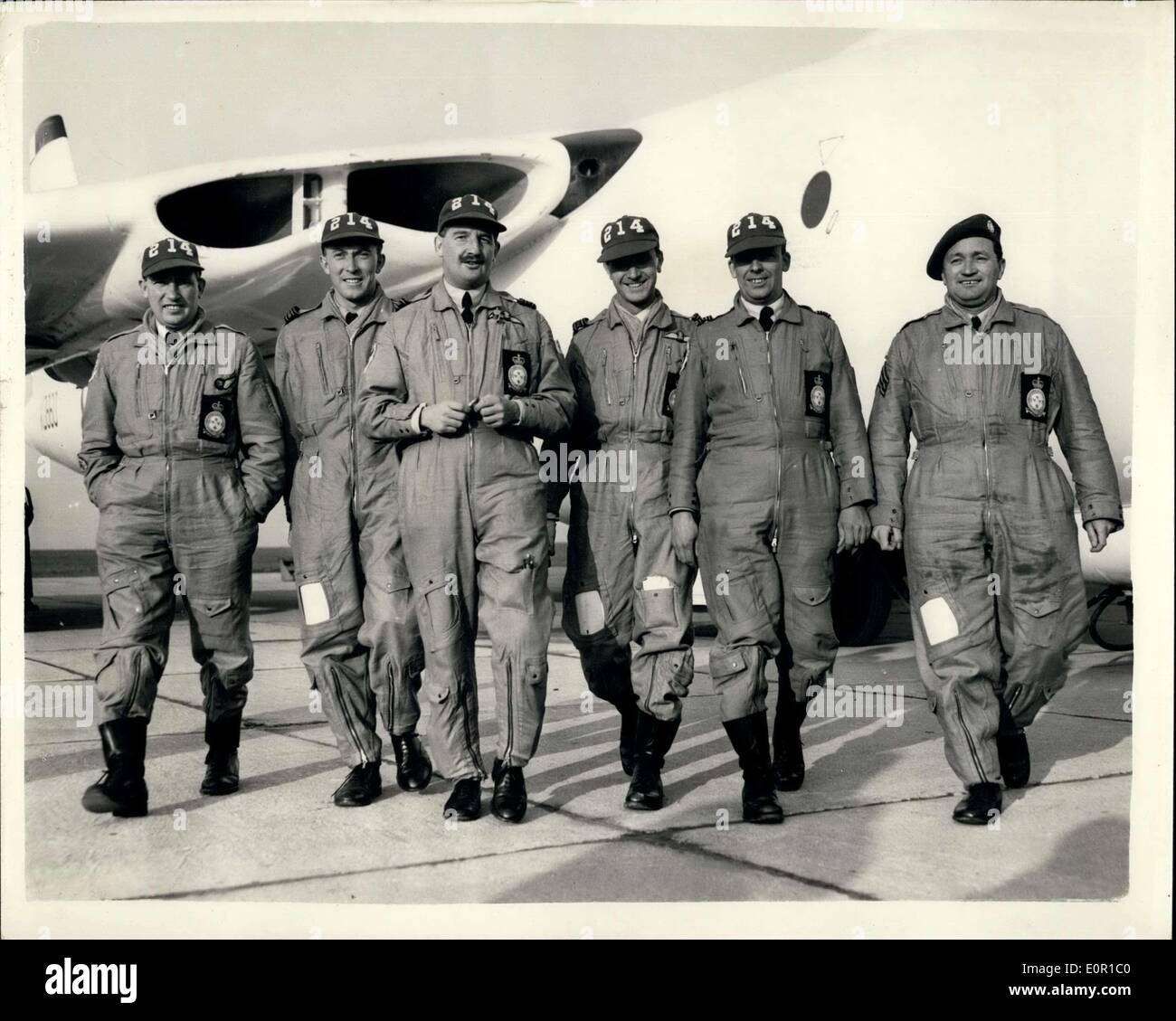 Aug. 11, 1957 - R.A.F. Crews Return from United States Bombing Tests. Land at Wittering - Northants.: The R.A.F. Bombing Teams who took part in the United States Strategic Air Com and's Bombing Contact - in Florida - returned to Wittering this afternoon. The teams returning including the Vliant which finished 11th. and 75th among the 90 crews. Photo shows complete with their ''American Kit'' - Master Sigaaller Eric Charles Brown; F/Lieut. George Bridson of Wigan - a Navigator; F/It. gordon Harper (31) co-pilot from Farmborough; S/LDR. Ronald Payne (34) Captain from London; S/LdR Stock Photo