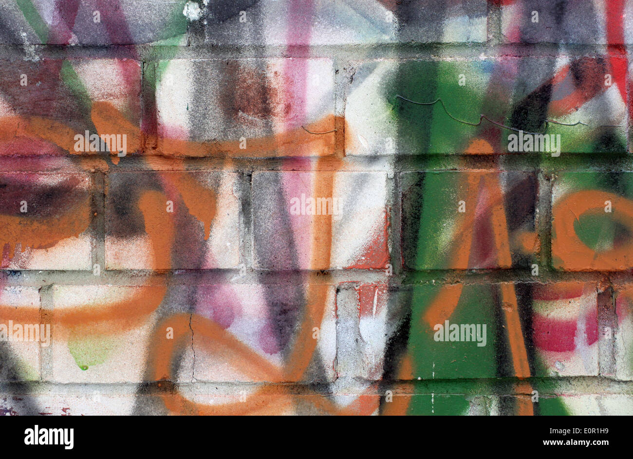 Colored graffiti textured background on the brick wall Stock Photo