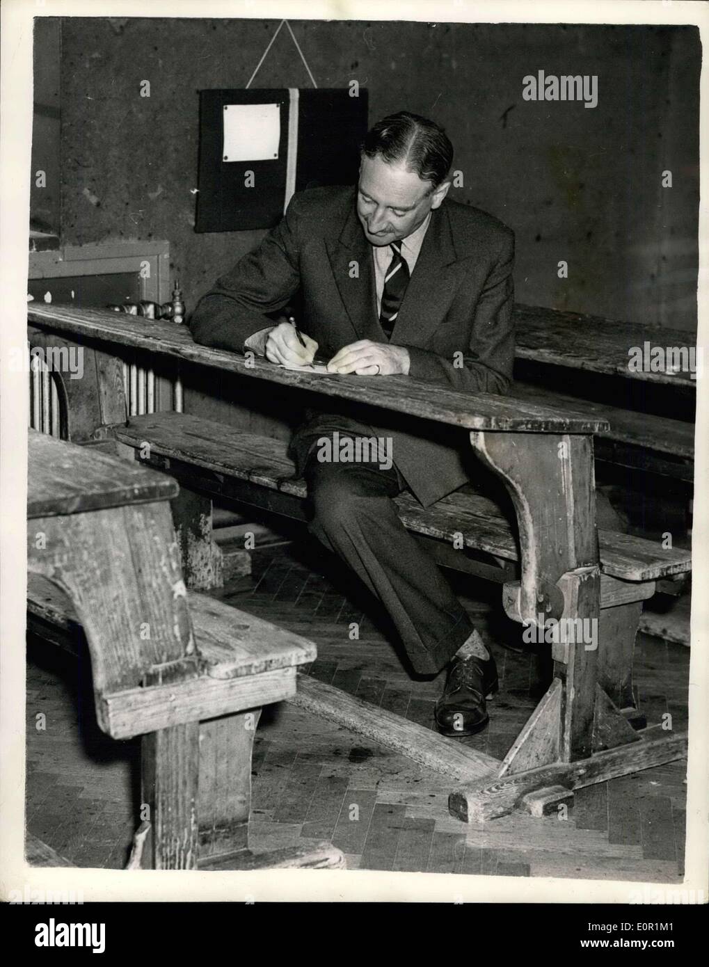 Sep. 02, 1957 - ''Open Day'' At Prince Charles New School: Members of the press attended an ''open day'' at Cheam School, Headley Newbury, today - where Prince Charles starts his first term on September 23rd. Photo shows Joint-headmaster Mr. Mark Wheeler, sits among the desks at Cheam School today. Stock Photo