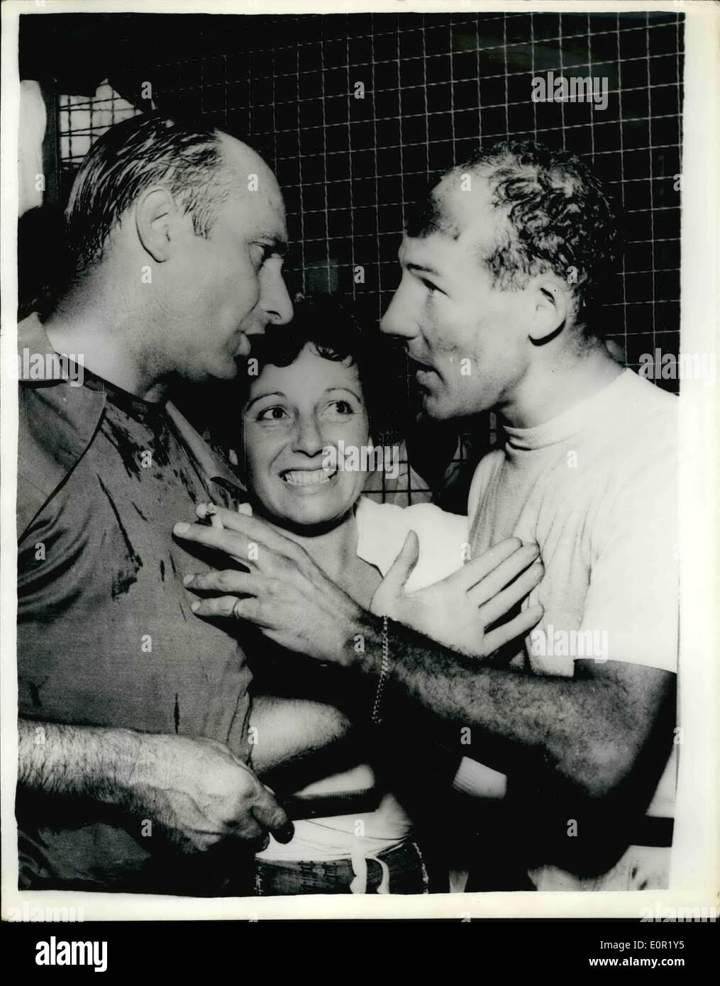 Sep. 09, 1957 - Stirling Moss Wins The Italian Grand Prix: Britain's Stirling Moss won the Italian Grand Prix at Monza on Sunday - in the all British Vanwall with a record average speed of 120.3 m.p.h. World Champion Juan Fangio was beaten into second place. Photo shows Juan Fancio on left congratulates Stirling Moss on his great victory at Monza. Stock Photo