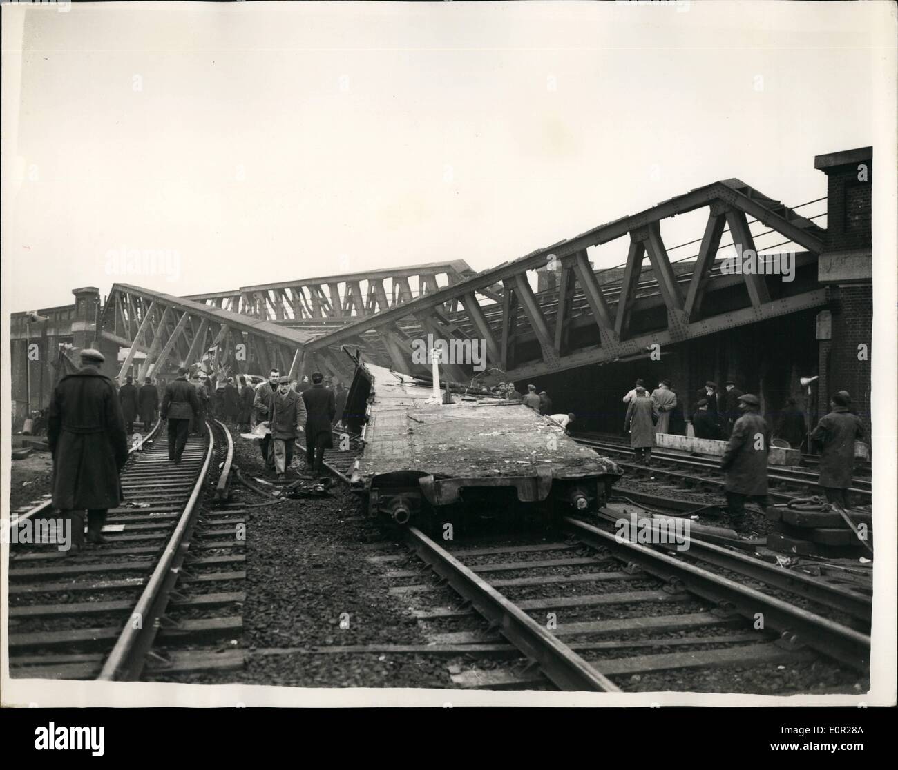 Dec. 12, 1957 - Rescue work goes on in the Lewisham Rail Crash Engineers try to Raise the Fly- over bridge. The death roll has now reached 92. in Wednesday night's Lewisham rail crash. Rescuers have toiled all night under are lights and early this morning engineers were trying o raise the wrecked bridge to clear the coach on which the full weight of the fly-over bridge fell. Photo Shows The first clear picture of the disaster taken after the fog had lifted today showing the fly-over bridge which collapsed on one of the trains after the crash Stock Photo