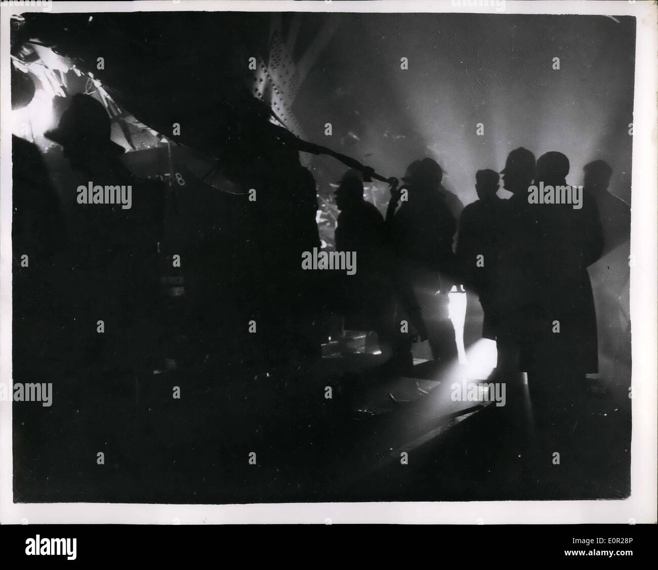 Dec. 12, 1957 - Tragic train crash in fog at Lewisham: More than forty people lost their lives when an electric train from Charing Cross to Hayes was struck by a steam train from Gem Street to al in dense fog just outside St John's station, Lewisham this evening. Part of a flyover crashed down on the wreckage. Photo shows firemen and rescue workers at the scene of the disaster this evening. Stock Photo