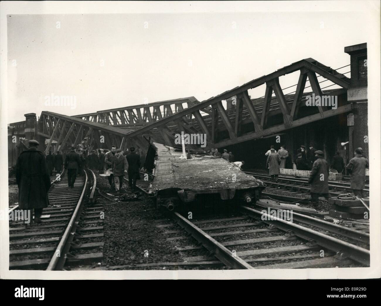 Dec. 12, 1957 - Rescue work goes o  the Lewisham rail crash engineers try to raise the fly-over bridge: The death roll has now reached 92 in Wednesday night's Lewisham rail crash. Rescuers have toiled all night under  are lights and early this morning engineers were trying to raise the wrecked bridge to clear the coach on which the full weight of the fly-over bridge fall. Photo shows the first clear picture of the disaster taken after the fog had lifted today showing the fly-over bridge which collapsed on one of the trains after the crash Stock Photo