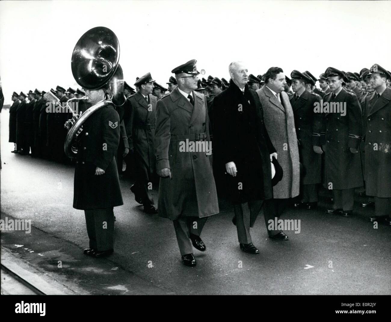 Dec. 12, 1957 - Four US-Air-Force bases turned over to German Air-Force: Four air-bases - Erding, Fuerstenfeldbruck, Landsberg and Kaufbeuren- have been turned over to the German Air-Force by US authorities. US Ambassador in Germany, Mr David K. E. Bruce and Germany's Secretary of Defense were present at Erding ceremony. Photo shows Left to right Colonel Elliot, as deputy of the commanding General of the US Air-Force, Ambassador David K.E. Bruce, and Germany's Secretary of Defense Franz Josef Strauss passing the honor guard of the German Air Force in Erding. Stock Photo