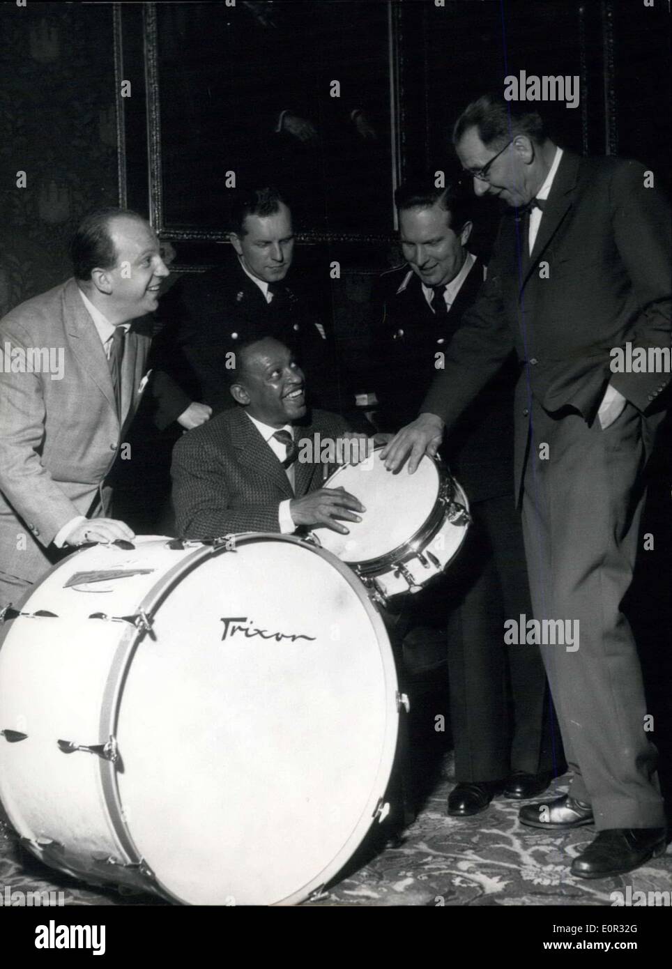 Dec. 30, 1957 - Kettledrum and drum for the police band The famous jazz musician Lionel Hampton was giving a kettledrum and a drum for present to the police ban of Hamburg at the town hall of Hamburg. Momentarily Lionel starts for a world trip, which began in Germany. Our Picture shows: Mr. Weimer from the firm Trixon, the policeman from the percussion instrument Winkler, Lionel Hampton, sitting, the leader of the police band Grenz, and police senator Dr. Kruger (all to be seen from left to right side) Stock Photo