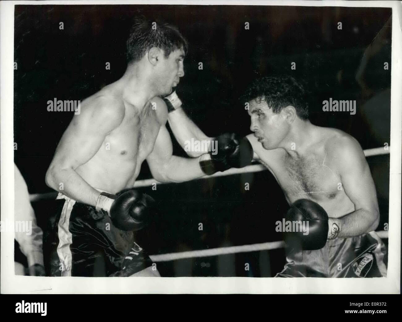 Nov. 11, 1957 - Willie Toweel Beats Jose Hernandez When Referee Stop The Contest In The Ninth Round: Willie Toweel, South African holder of the Empire Lightweight title, beat the Spanish Southpaw, Jose Hernandez, when the referee stopped the contest in the ninth round of their ten-round international lightweight contest at the Albert Hall, London, this evening. Hernandez sustained a badly out eye. Photo shows Willie Toweel (left) about to deliver a left hook as he slips inside Hernandez's right. Stock Photo