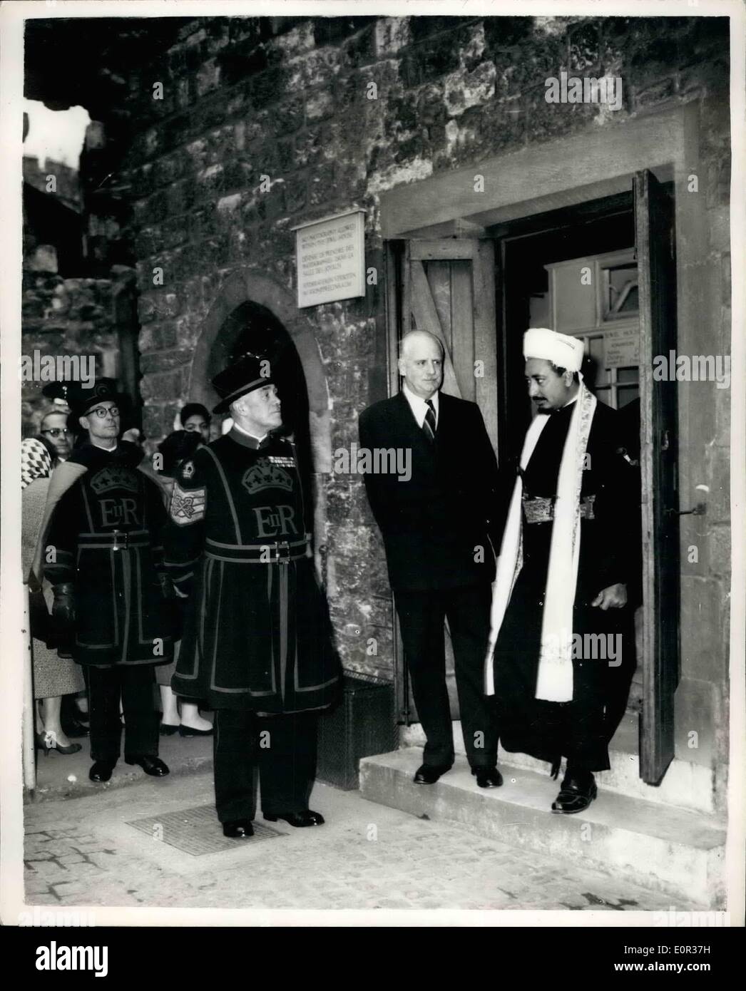 Nov. 11, 1957 - The Crown Prince of Yemen visits the tower of London: Prince Mohammed Al Badr, the Crown Prince of Yemen, who is also his country's Foreign Minister, is in this country on a ten-day visit as guest of the British Government. This morning he paid a visit to the Tower of London. Photo Shows The Crown Prince Yemen seen with Brigadier D.F. Wieler, Governor of the Tower, as they leave the Jewel House watched by Yeomen Wardors of the Tower. Stock Photo