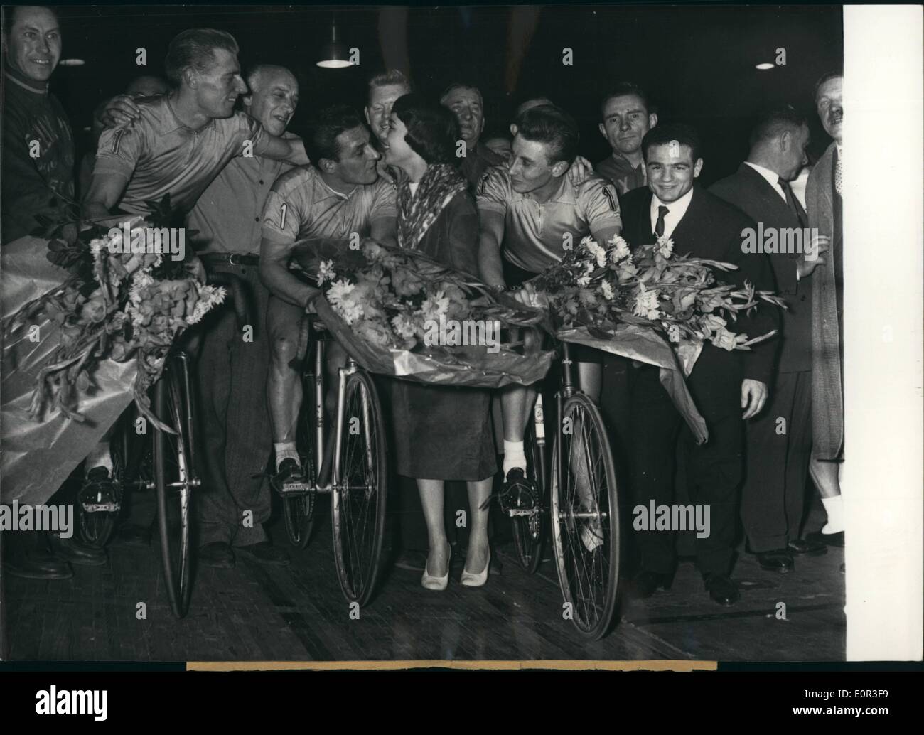 Nov. 11, 1957 - Anquetil And His Tow Team-Mates Win Paris Six Day Bicycle Race. The six day bicycle race which finished at Velodromed' Hiver was won by Jacques Anquetil and his two team mates, the Frenchman Darrigade and the Italian Terruzzi. From left to right: Darrgade, Terruzzi (kissing the queen of the six days, Annie Fratellini) and Jacques Anquetil. Stock Photo