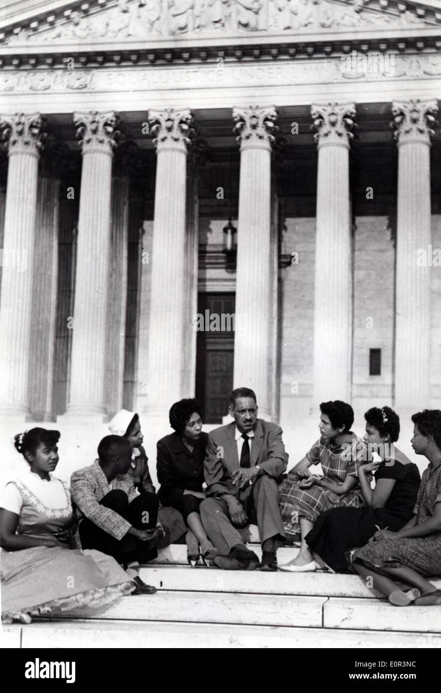 Jan. 01, 1958 - Washington, District of Columbia, U.S. - File Photo: circa 1958. alf a century after the historic ruling in Brown v. Board of Education that overturned segregation in education, the US is marking 50 years of racial school integration. After the 1954 Brown school-desegregation decision, Little Rock school board officials decided to begin desegregation of Central High School in September 1957. THURGOOD MARSHALL (C), sits on the high court steps with students from Little Rock, Arkansas, after appealing 1958 court order to delay integration at their school. He won the appeal. Stock Photo