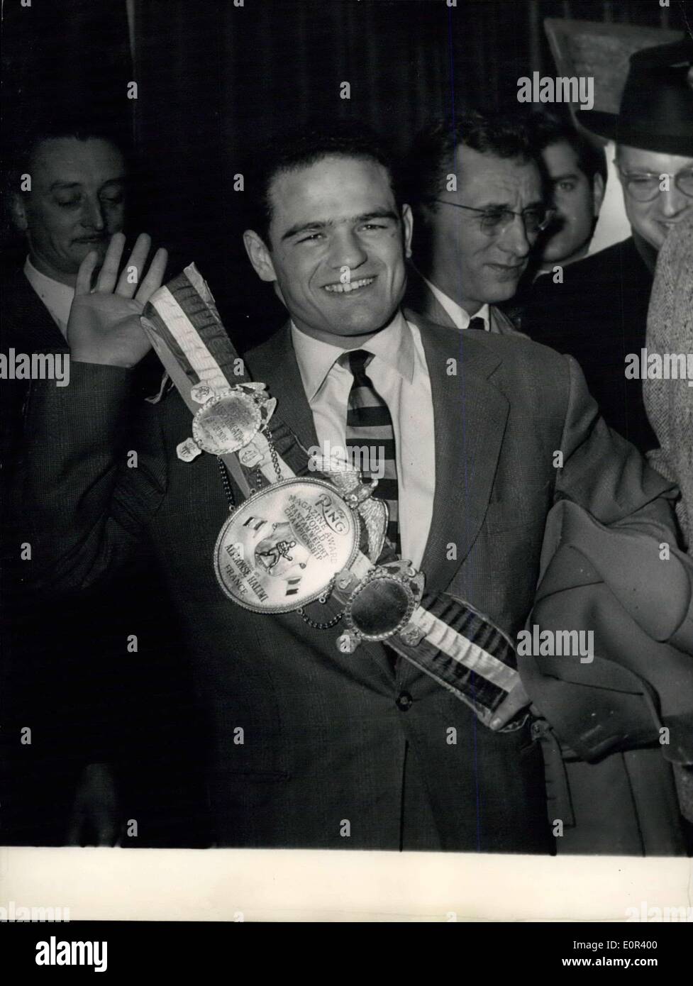 Nov. 13, 1957 - Halimi Back In Paris: Alphonse Halimi who won the title of the world lightweight champion after his fifty with Macias in Los Angeles recently returned to Paris today. Photo shows Halimi seen proudly exhibited his champion's belt awarded by the American ''Ring Magazine'' on his arrival at Orly Airport this morning. Stock Photo