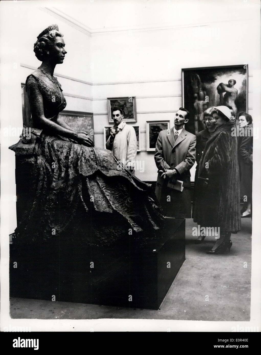 Nov. 15, 1957 - Private View of Regal Society of British Artists Exhibition - A Private View was held this morning at the Suffolk Street Galleries - of the Royal Society of British Artists' Exhibition. Keystone Photo Shows:- Visitors to the Exhibition - looking at the Sttes of the Queen - Created by Nigerian Sculpter - Mr. ENWOING. Stock Photo