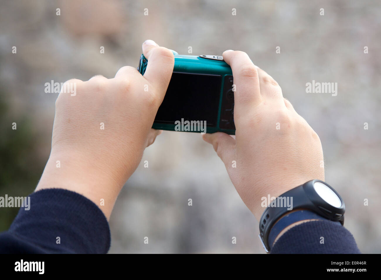 Hands taking a picture with a point and shoot camera. Stock Photo