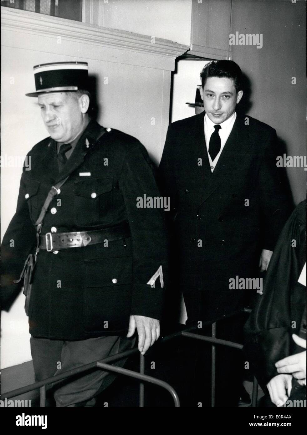 Dec. 12, 1957 - Francis Bodenan tried for double murder; Francis Bodenan involved in the murder of two Paris tradesmen Louis Robinard and David Saban at Montfort L'Amaury, near Paris, last year, appeared before the Versailles court of assizes today. Photo Shows Francis Bodenan arrives under Escort in the court room. Stock Photo
