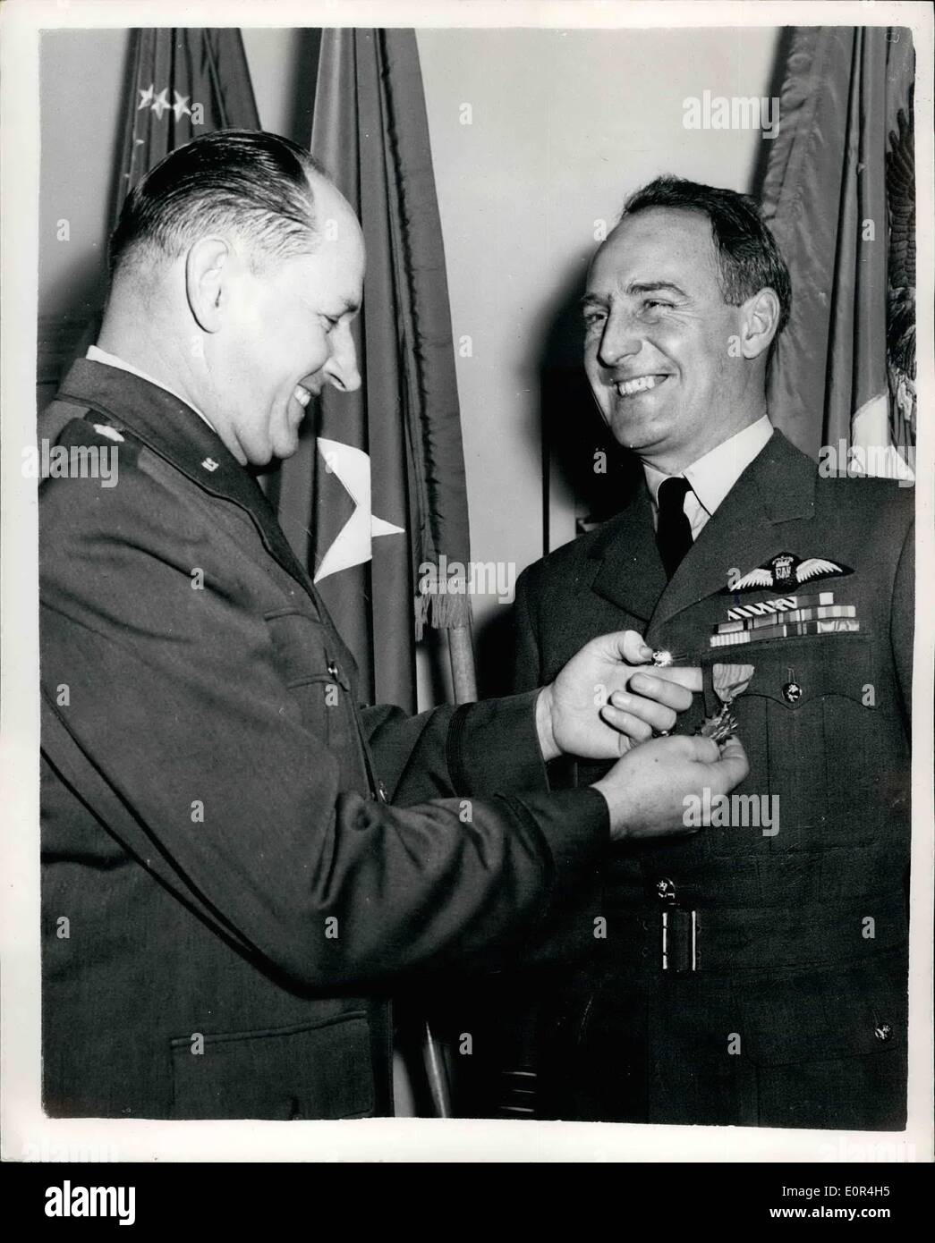 Mar. 03, 1958 - R.A.F. Officer recieves United States air medal award.: Squadron Leader Colin L. Blythe D.F.C., A.F.C., R.A.F. this afternoon received the United States Air Medal from Brig. Gen. Frank B. James, United States Air Attache - at latter's London office. The award was made fo ~~~~~. Blythe's acts of meritorious service during the United Nations activities in Korea from March - August 1951. At that time the Sdr. Ldr. was serving with No. 77 Sqd. Royal Australian Air Force attached to the 5th. U.S. Air Force, United Nations Command. Photo shows Squadron leader Colin I. Blythe, D.F.C Stock Photo