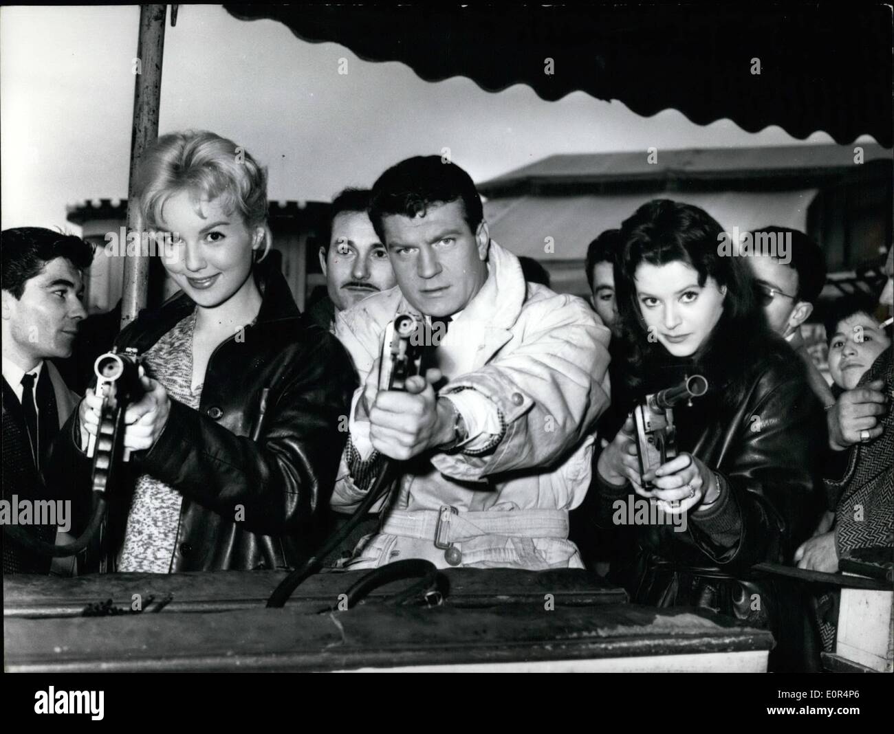 Feb. 02, 1958 - Hold-Up? No,Movies: A Sequence Of Marc Allegret's New Film ''Sois Belle Et Tais-Toi'' (Be Beautiful And Keep Quiet) Was Made At La Villette Fair, In Paris, Today. Photo shows From Left To Right: Mylene Demangeot : Henri Vidal And Alta Riba, The Actors Co-Starring In The Film, Having Some Fun In A Shooting Gallery. Stock Photo