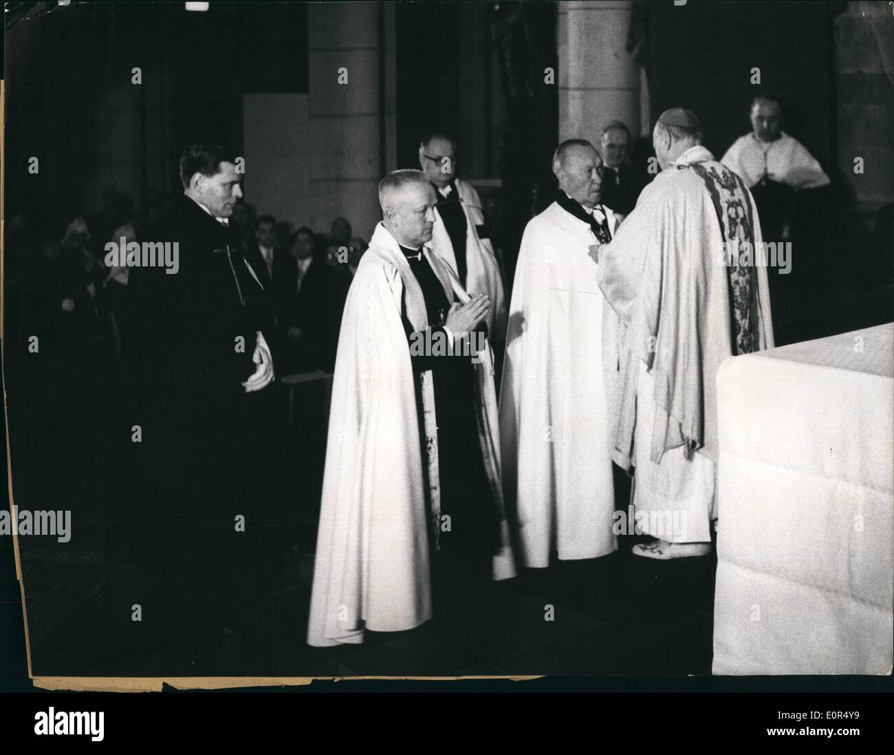 Mar. 03, 1958 - Federal Chancellor Dr. Adenauer Knight of Honour of The German Order. The Grand master of the German Order, Abbot Marian Tumler was admitting the Federal Chancellor Dr. Konrad Adenauer as Knight of Honour of the German Order. The Austrian Federal Chancellor Raab, staging as assistant of honour for his German colleague, also was present at the solemn inauguration in the Andreas-Church of Cologne. Our picture shows: The Grand Master of the German Order, Abbot P. Marian Tumler, bestowing his blessing to the new Knight of Honour Dr. Konrad Adenauer. Stock Photo