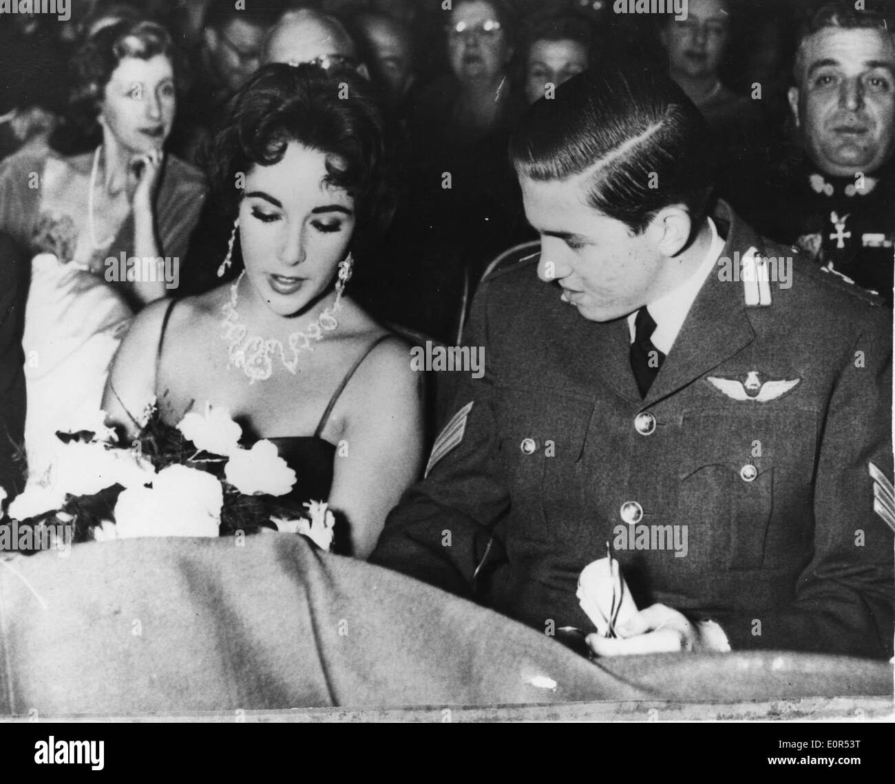 Feb. 5, 1958 - Athens, Greece - Academy Award winning actress ELIZABETH 'LIZ' TAYLOR is in Athens with husband Mike Todd for the 'Round the World in 80 Days' premiere. PICTURED: Liz Taylor chats with PRINCE CONSTANTINE II of Greece at the Radio City Theatre. Stock Photo