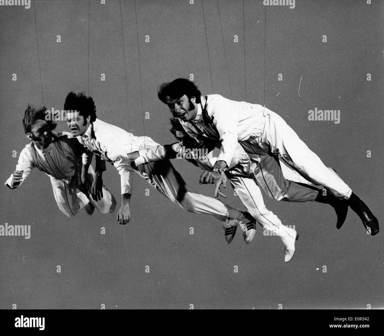 The Monkees swinging in the air filming their new video Stock Photo