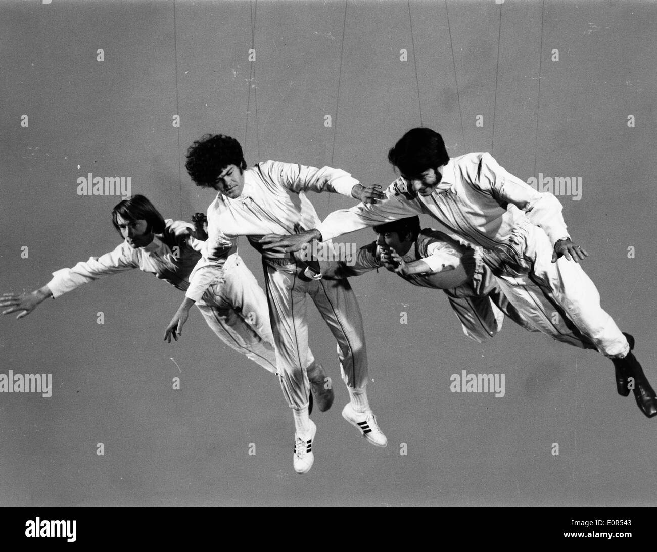 The Monkees swinging in the air filming their new video Stock Photo