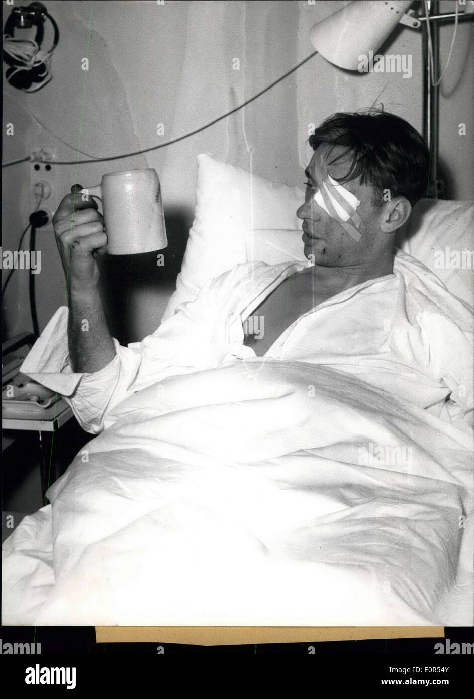 Feb. 11, 1958 - In the hospital at the right side of the Isar in Munich several injured members of the foot-ball team Manchester United, injured at the aircraft's catastrophy at February 7,58 in Munchen-Riem, already are on the way of recovery. Picture 1, Kwn Morgan sitting in a wheel chair on the way to the X-rays. Picture 2, Bobby Charlton already is drinking out of a genuine Bavarian beer-tankard. Picture 3, Wood Raymond (left side) and Bobby Charlton (right side) already are able to laugh Stock Photo