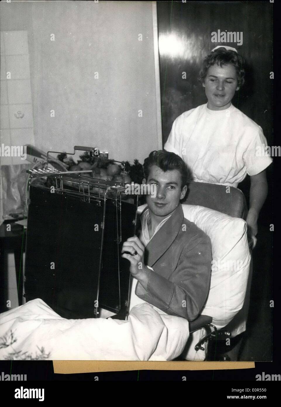 Feb. 11, 1958 - In the hospital at the right side of the Isar in Munich several injured members of the foot-ball team Manchester United, injured at the aircraft's catastrophy at February 7,58 in Munchen-Riem, already are on the way of recovery. Picture 1, Kwn Morgan sitting in a wheel chair on the way to the X-rays. Picture 2, Bobby Charlton already is drinking out of a genuine Bavarian beer-tankard. Picture 3, Wood Raymond (left side) and Bobby Charlton (right side) already are able to laugh Stock Photo