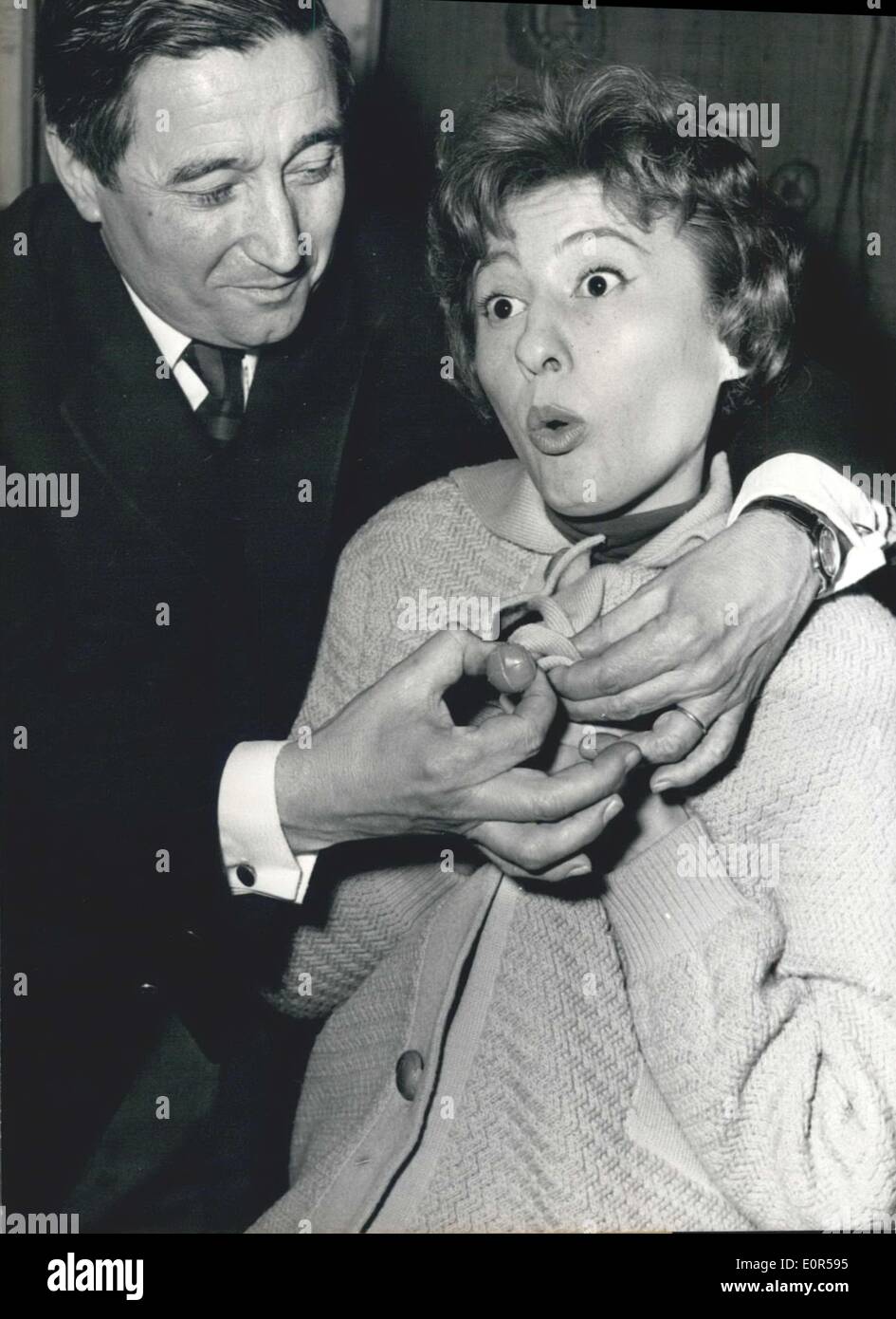 Mar. 11, 1958 - Singer Lucette Raillat gets help with buttons on her ...